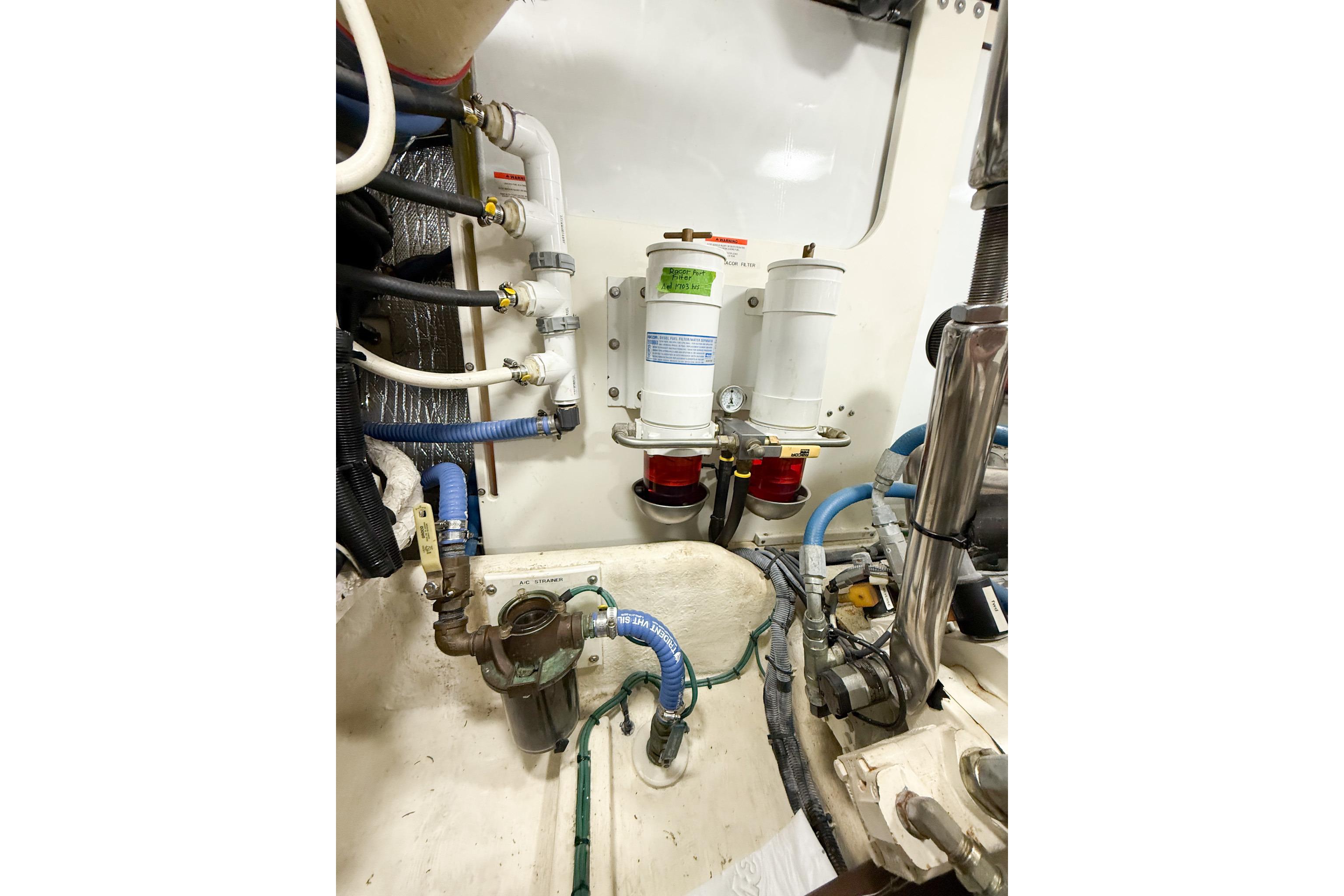 Engine room of 2007 Nordic Tug 54 with fuel filters and hoses.