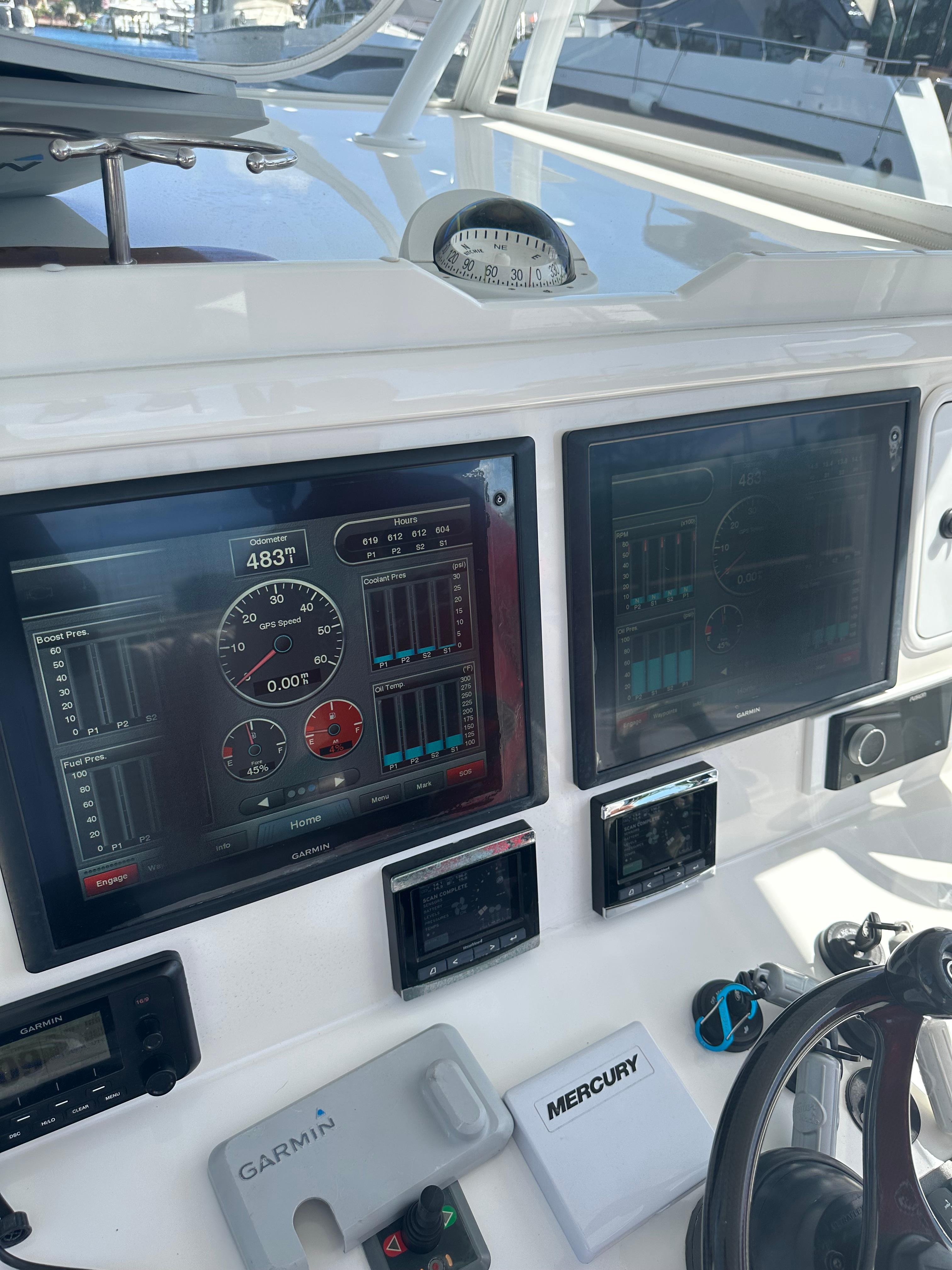 2016 Invincible Open Fisherman boat dashboard with Garmin and Mercury displays.