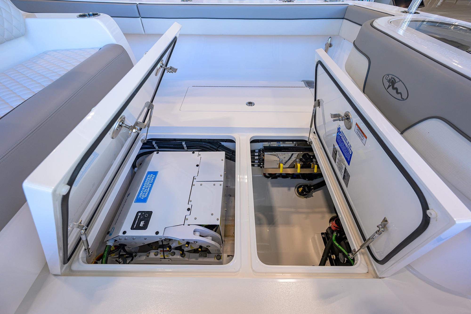 2025 Valhalla Boatworks V-37 storage compartments open, showcasing interior equipment and wiring.