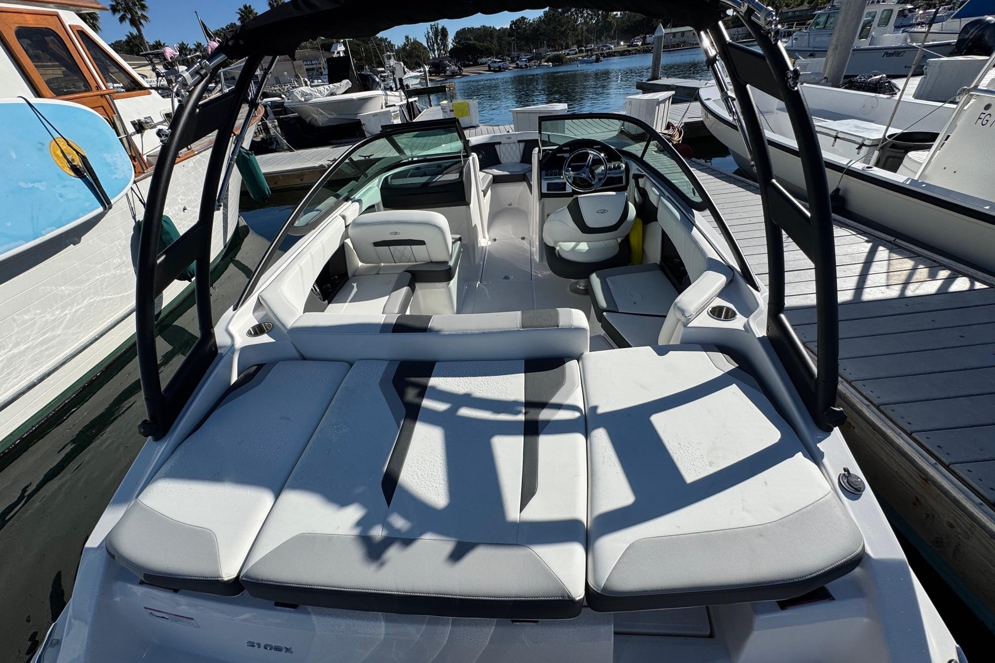 2026 Regal 21 OBX boat docked, featuring sleek white seating and modern design.