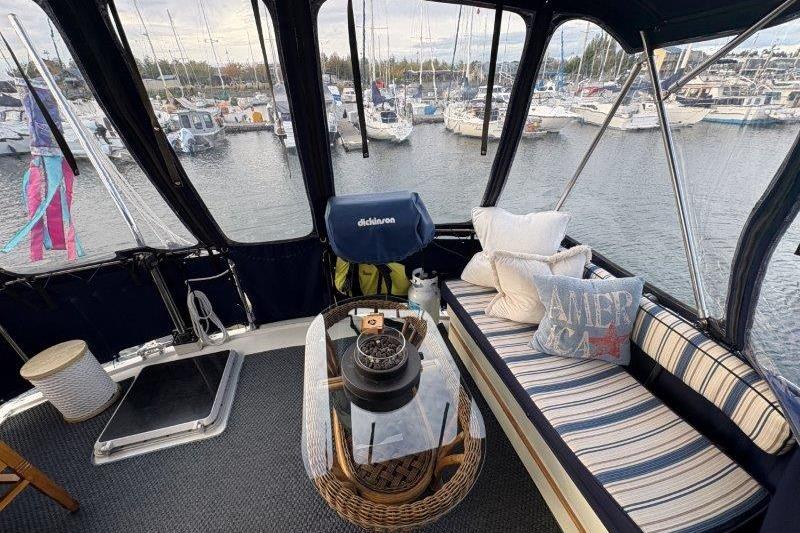 1987 Tollycraft 34 Sundeck Motor Yacht interior with cozy seating and marina view.