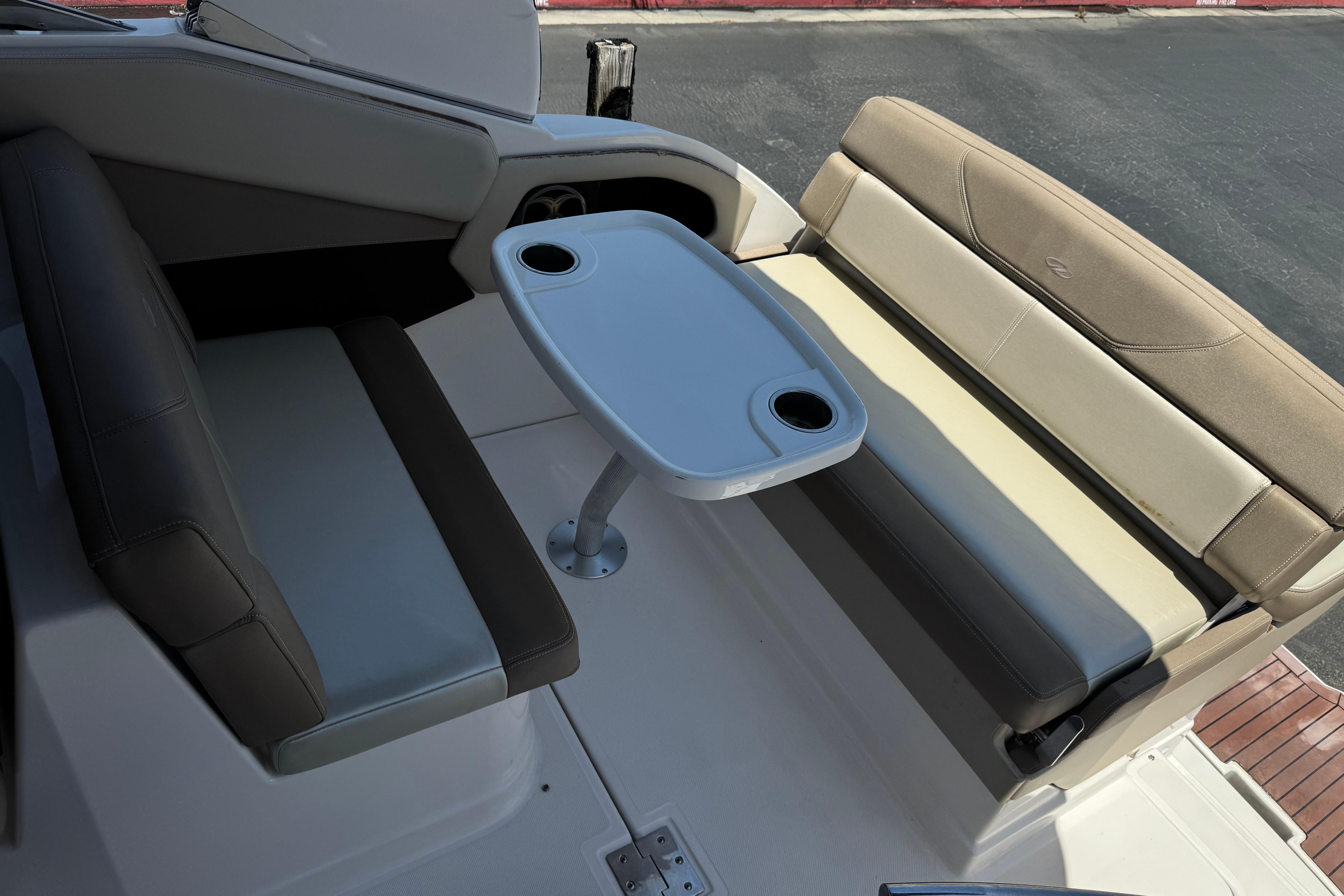 2013 Regal 28 Express boat interior with seating and table setup.