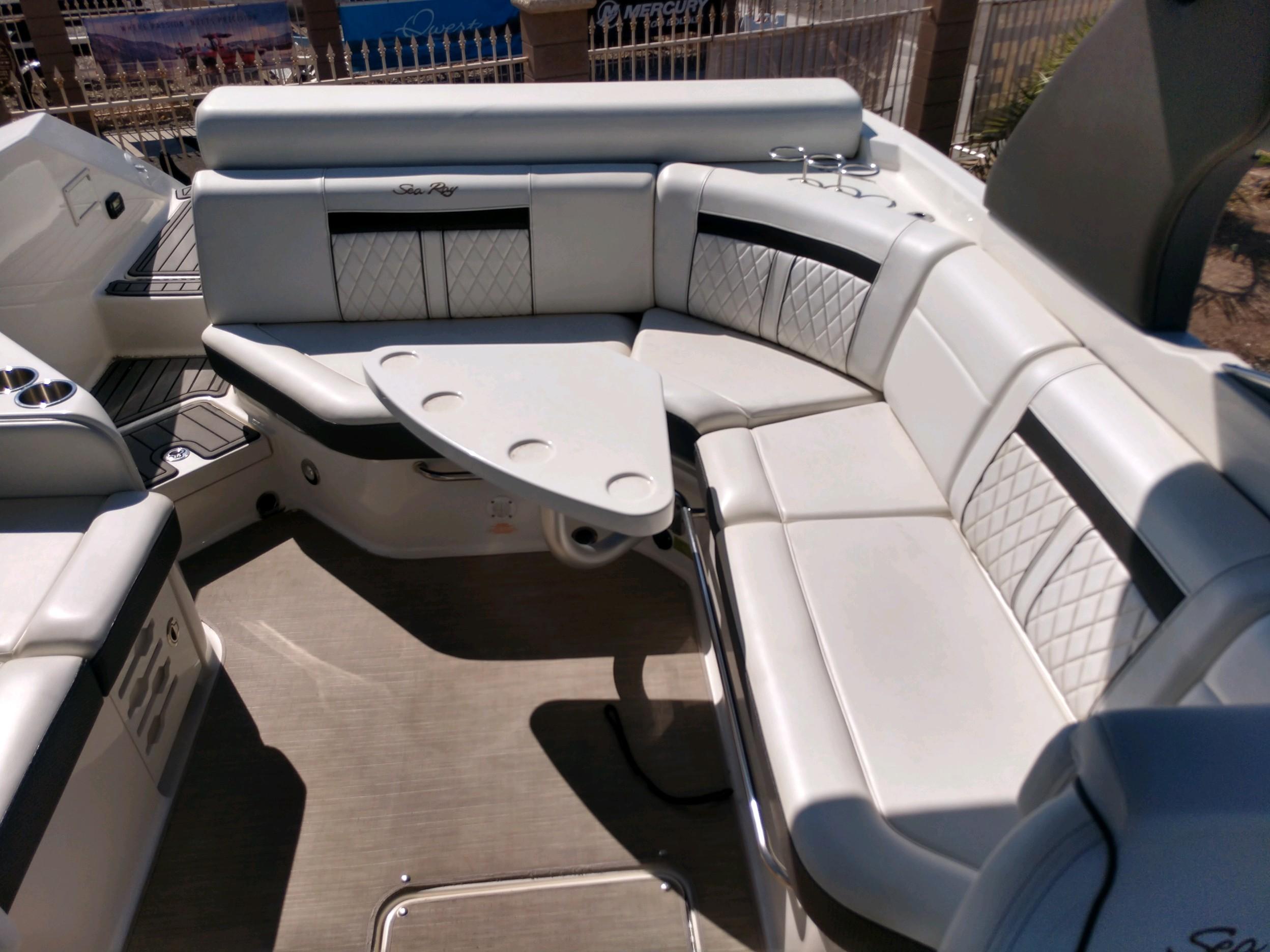 2018 Sea Ray SLX 280 boat interior with white leather seating and table.