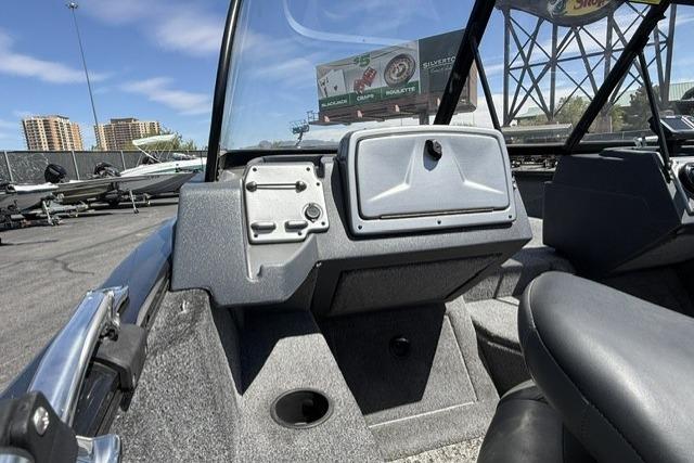 2025 Tracker Pro Guide V-175 WT boat interior with dashboard and seating, under clear blue sky.