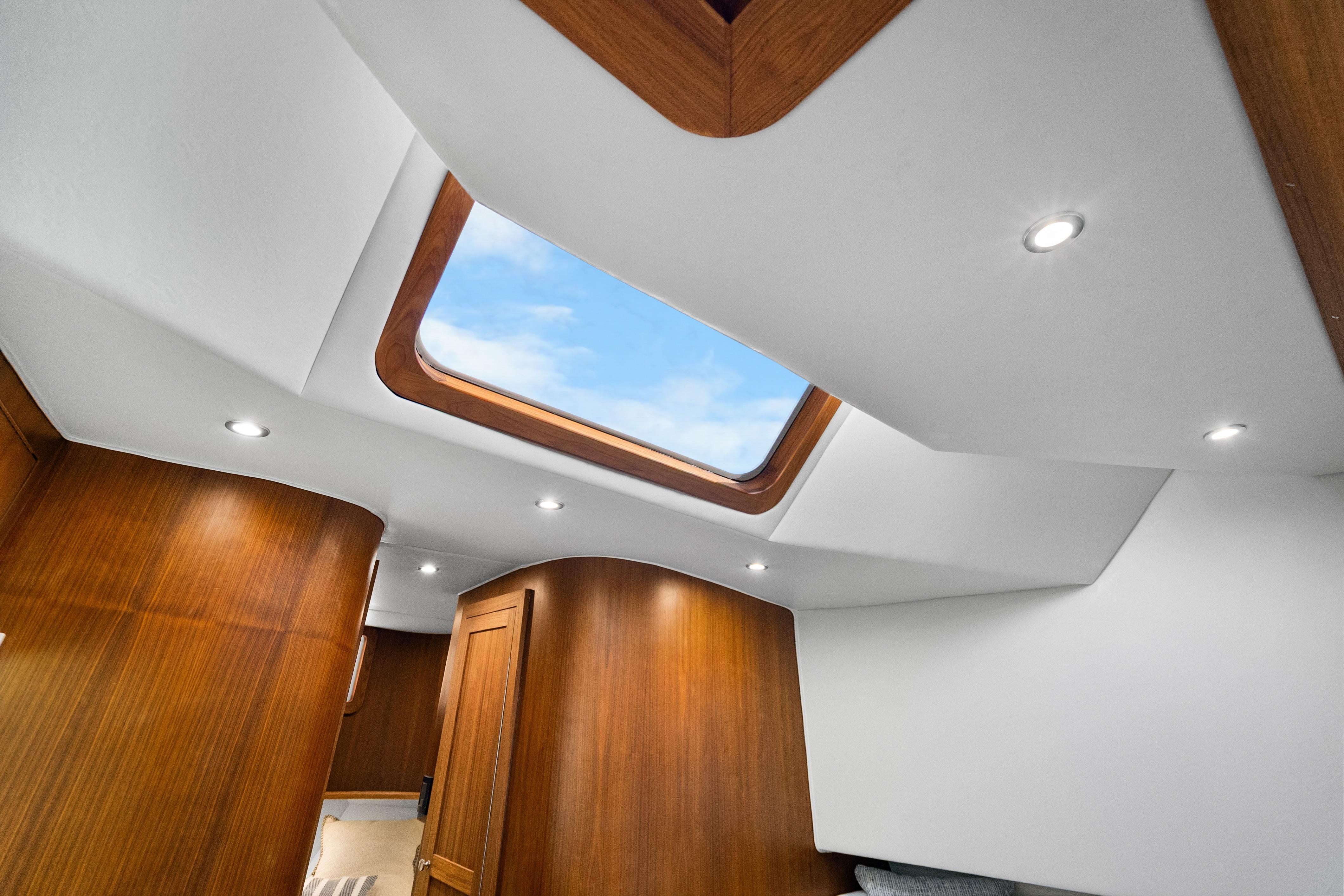 Interior of 2025 Rybovich Custom Margaritavich yacht with skylight and wooden paneling.