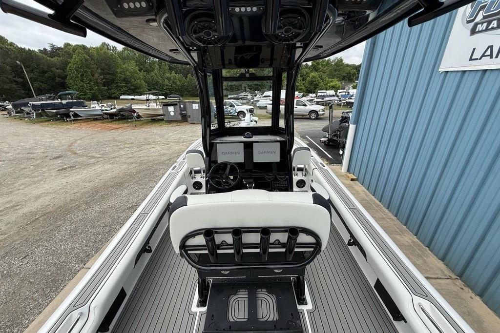 2026 Tidewater 2500 Carolina Bay boat interior with Garmin navigation, docked near blue building.