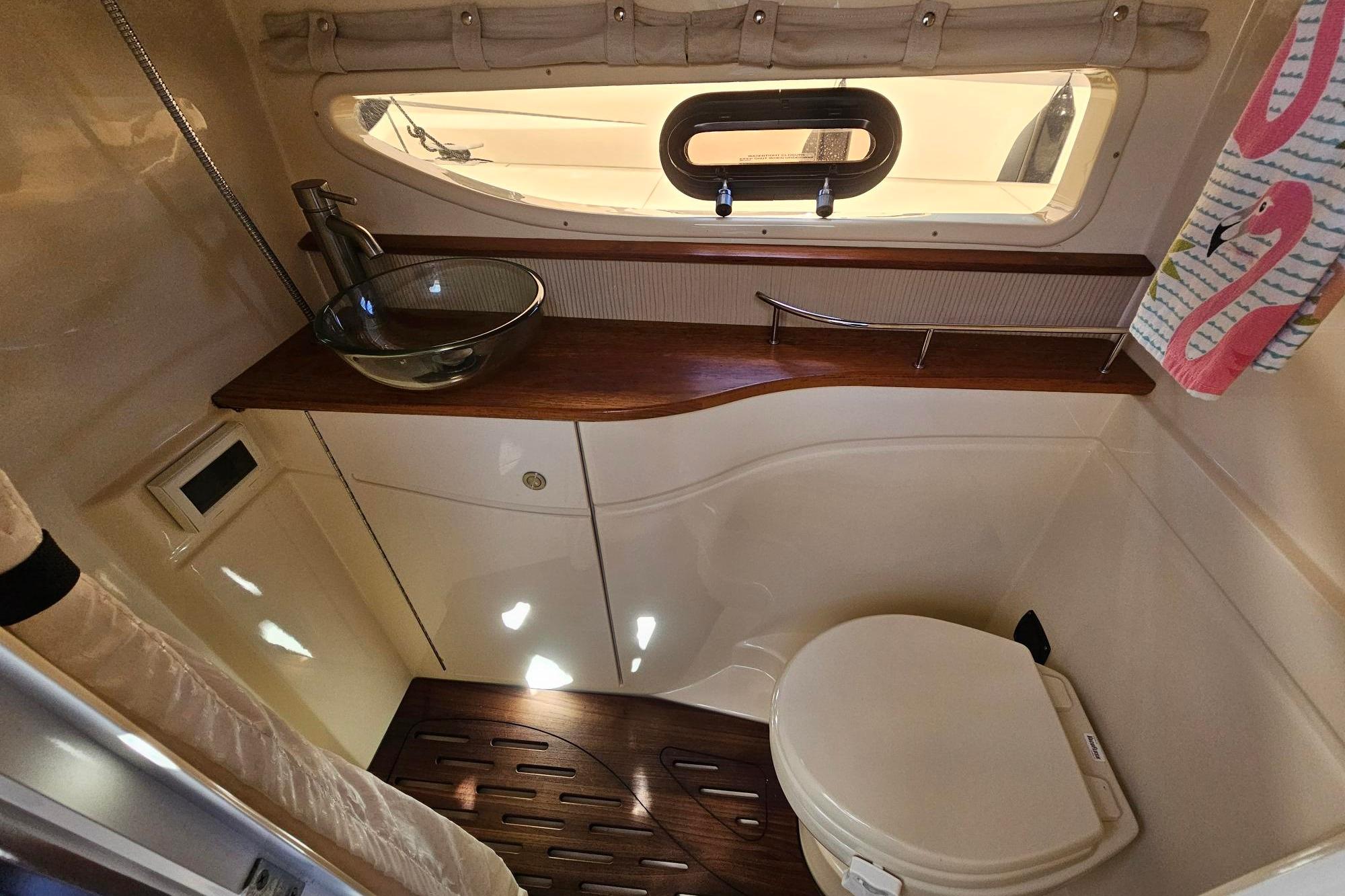 Luxurious bathroom in 2016 Sea Ray Sundancer 350 yacht with modern fixtures and elegant design.