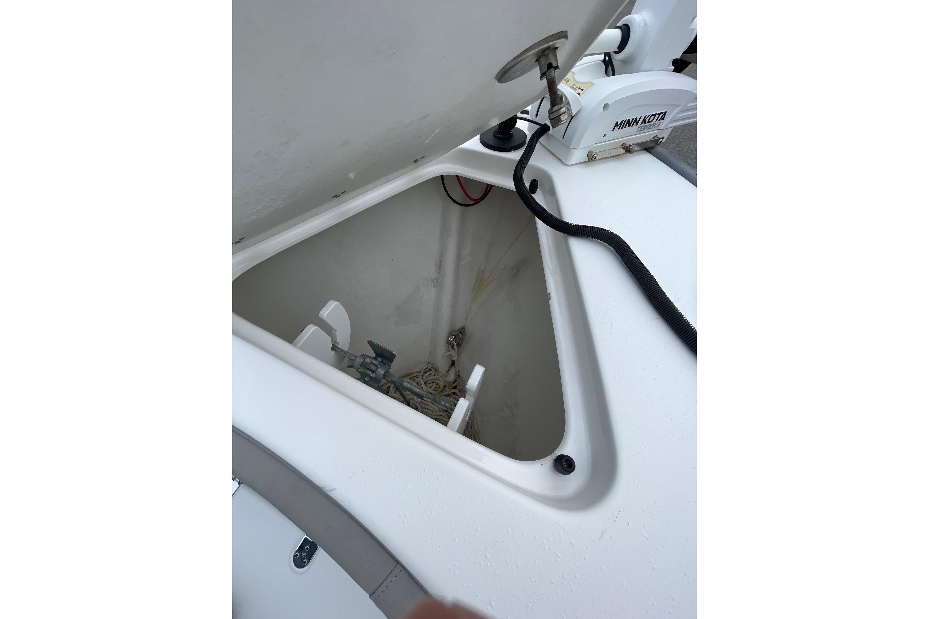 Open storage compartment on 2023 Cape Horn 24 XS boat with Minn Kota equipment.