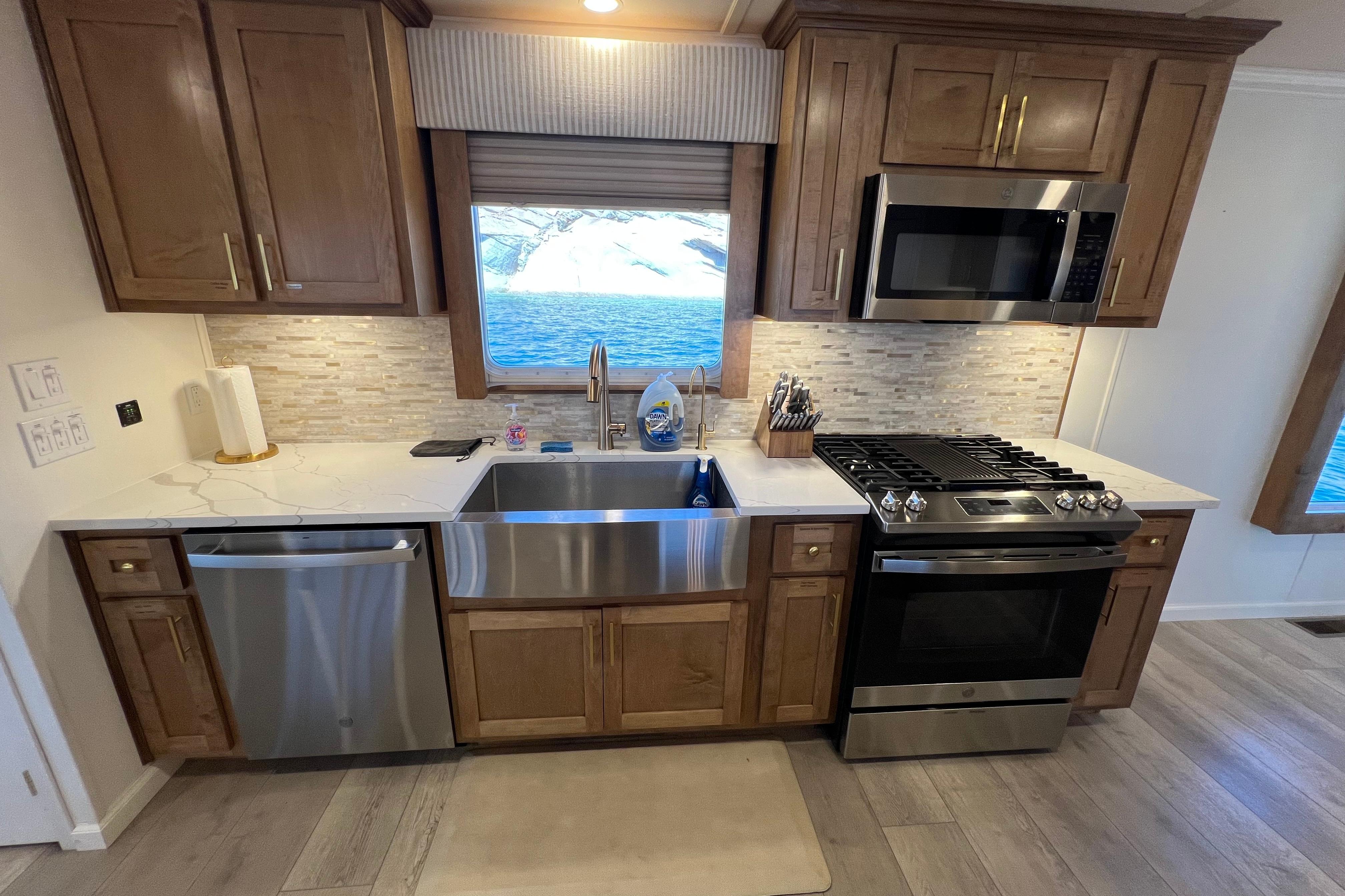 Modern kitchen in 2025 Sumerset Excellence Multiple Shares houseboat, featuring stainless steel appliances and wood cabinetry.