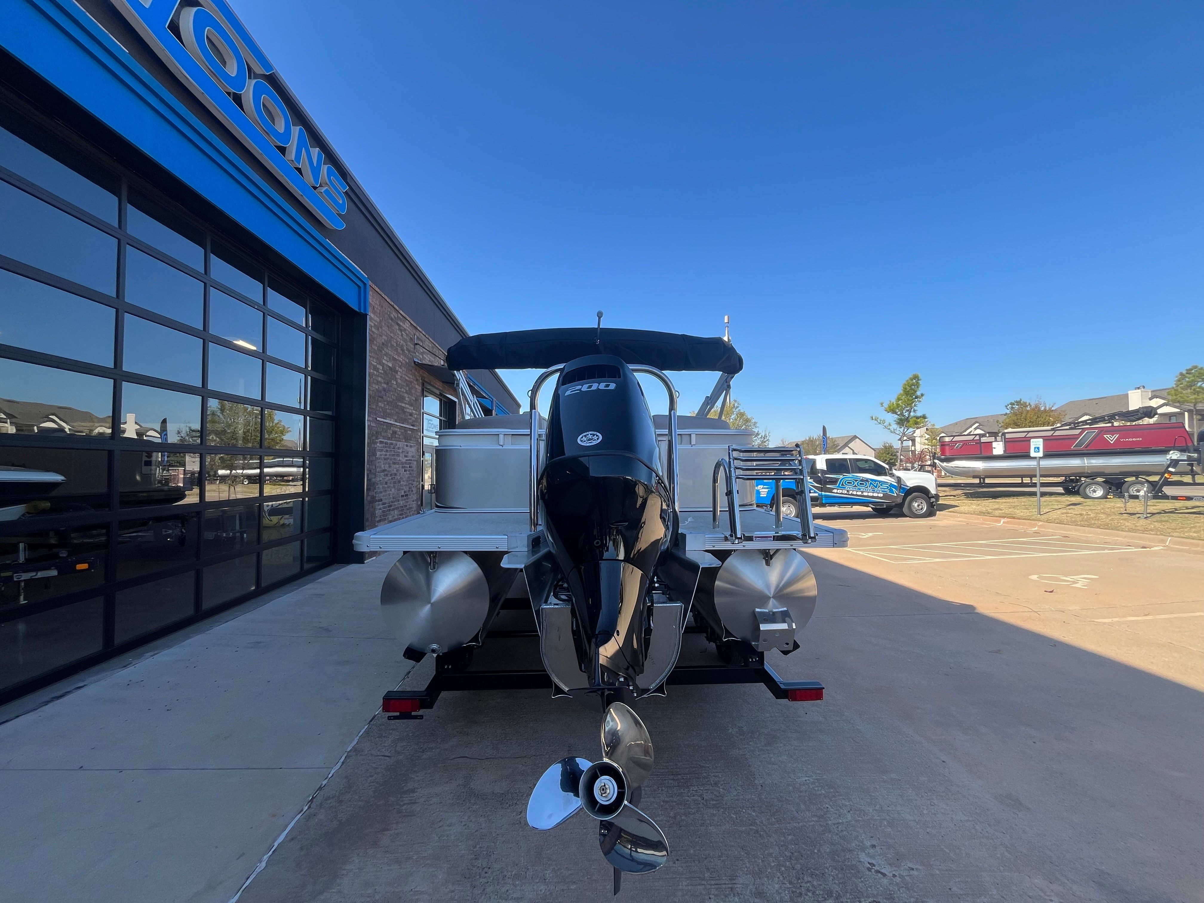 2026 Tahoe 2385 LTZ Quad Lounger boat, exterior view, blue sky.