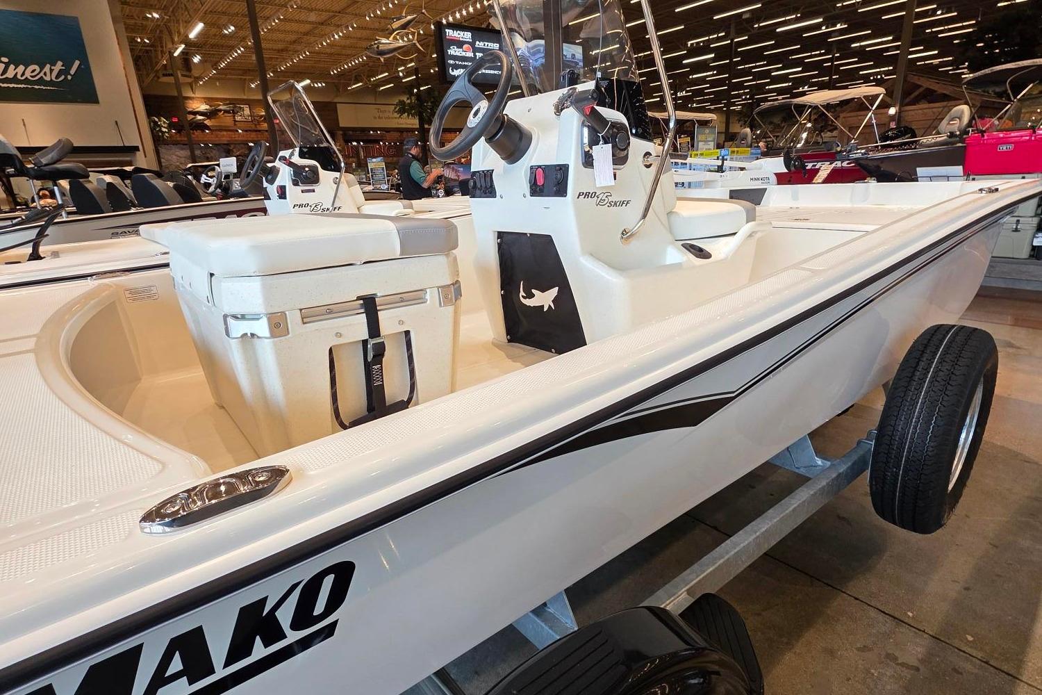 2026 Mako Pro Skiff 15 CC boat displayed indoors, showcasing sleek design and modern features.