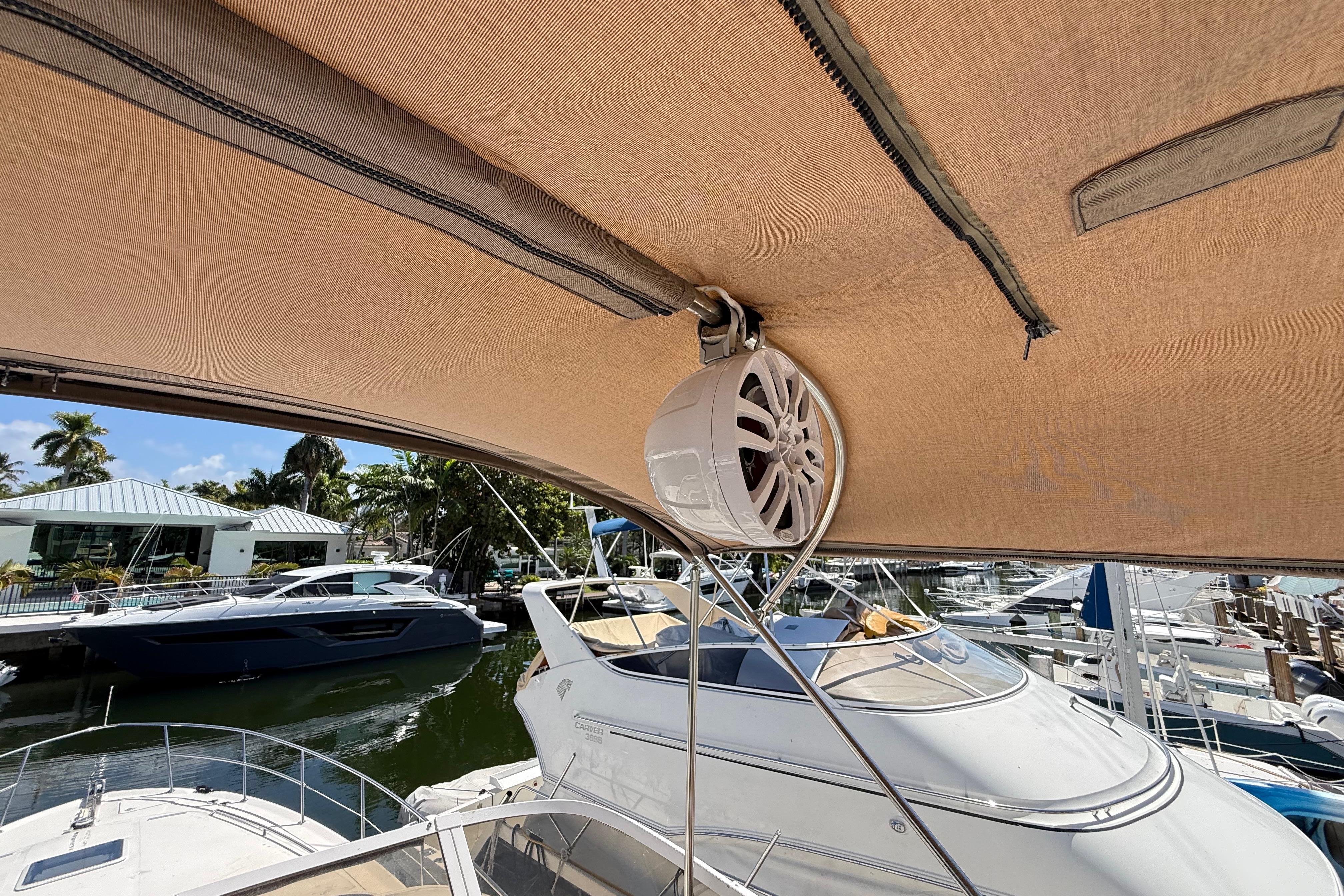1998 Sea Ray 400 Sedan Bridge with canopy and speaker, docked at marina.