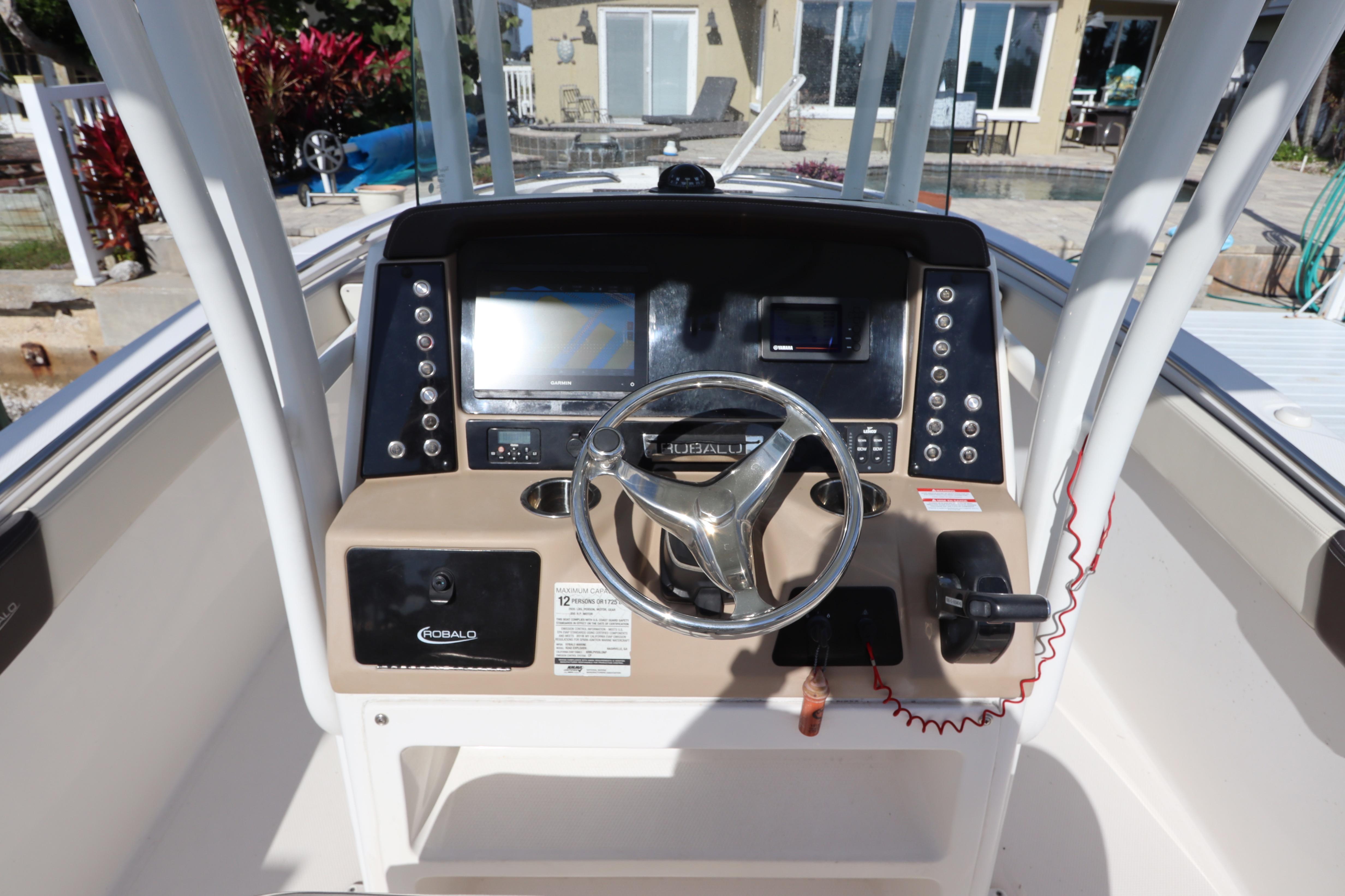 2019 Robalo R242 Center Console boat dashboard with steering wheel and controls.