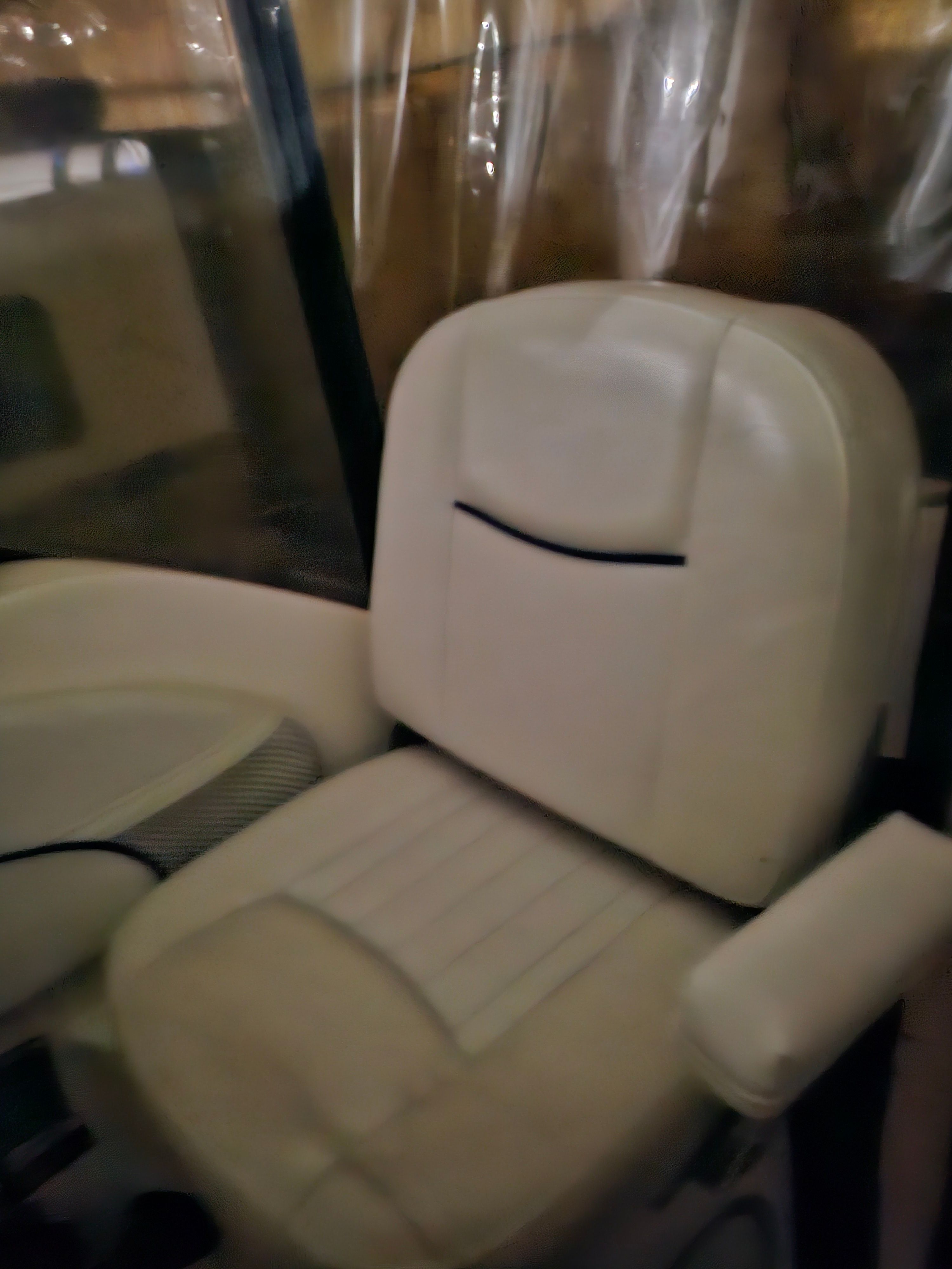 A beige boat seat with armrest in a 2005 Bayliner 242 Ceara.