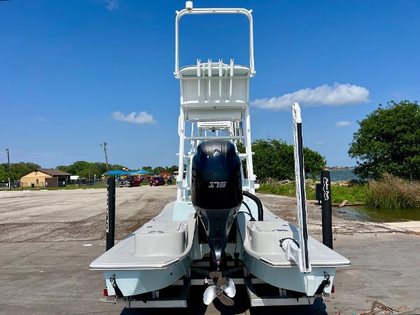 2022 Shallow Sport 20 Classic boat with outboard motor, docked under clear blue sky.