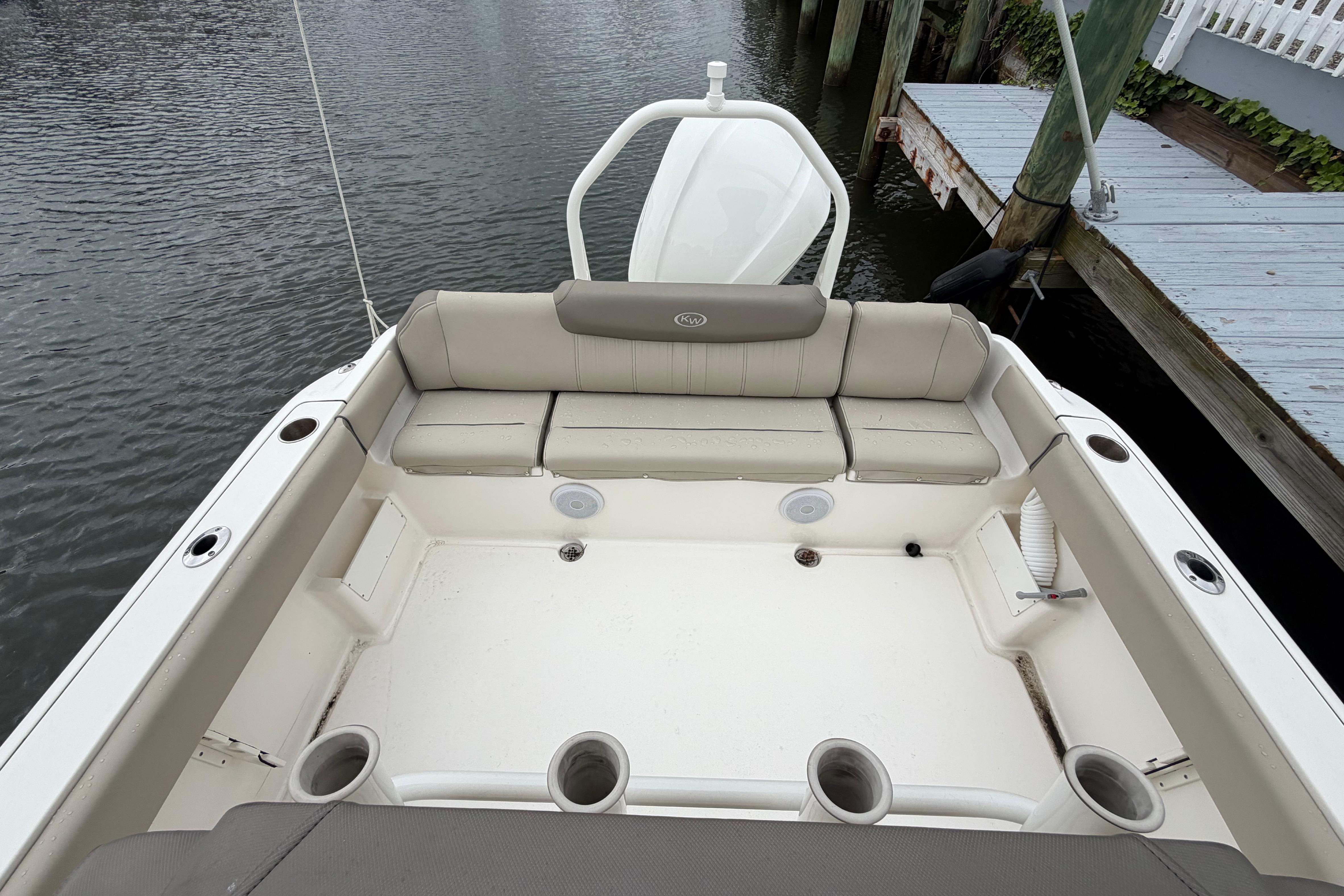 2022 Key West 239 FS boat interior with cushioned seating and cup holders.