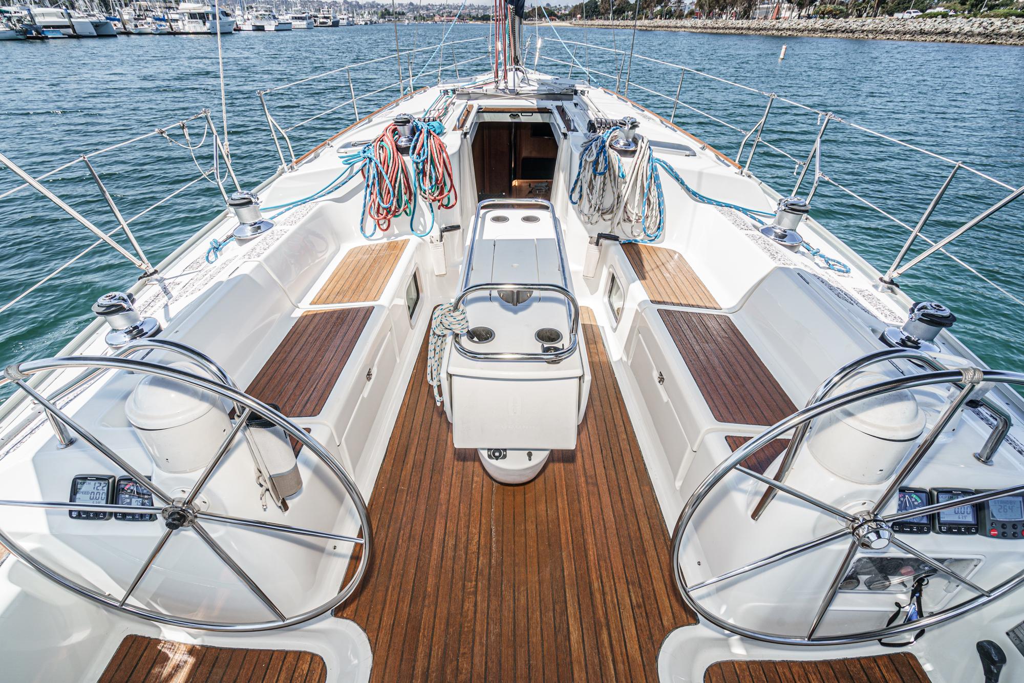 Jeanneau Sun Odyssey 43 sailboat cockpit, 2002 model, with dual steering wheels and teak decking.