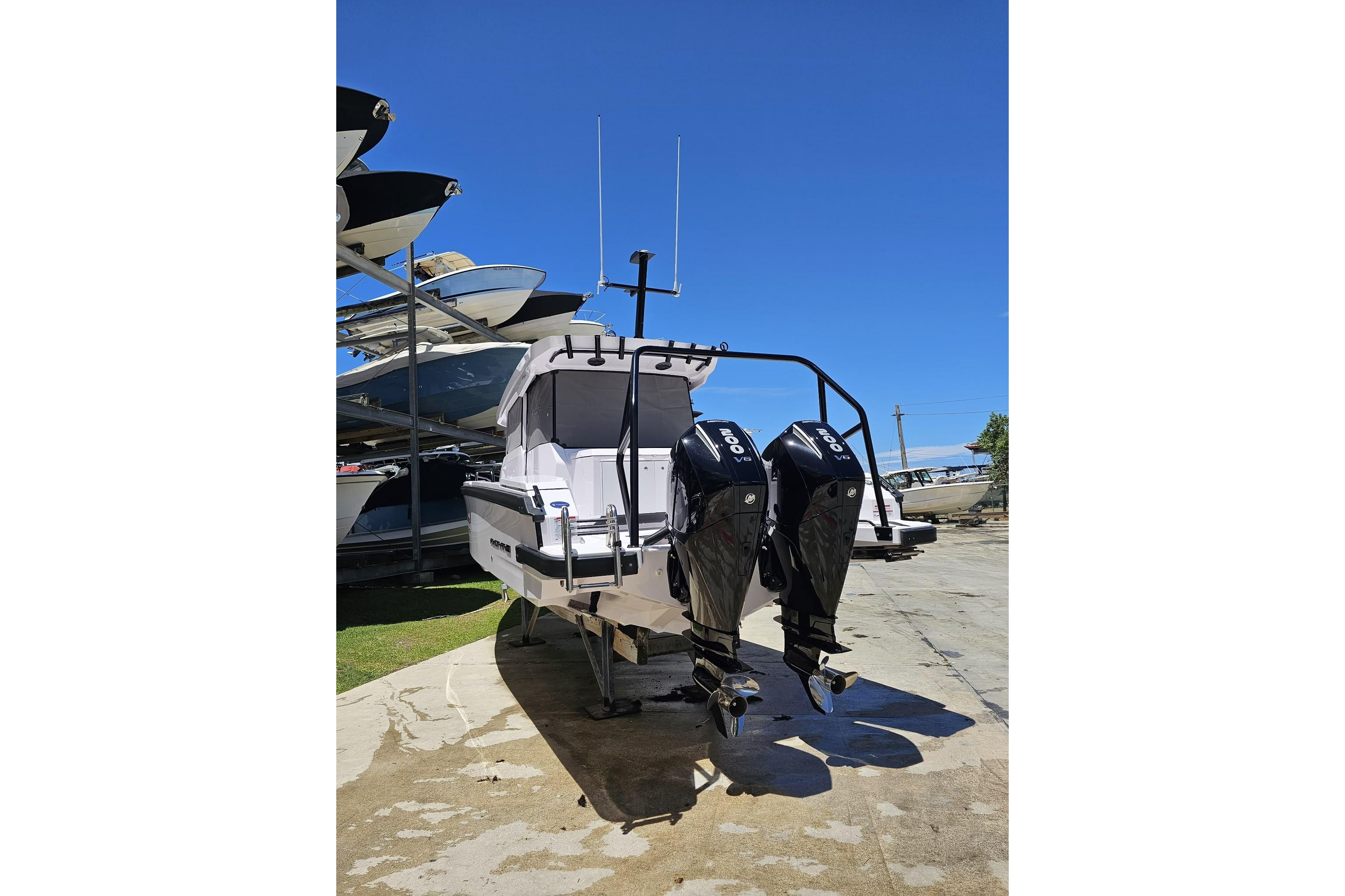 2025 Axopar 29 XC Cross Cabin with dual outboard engines on a sunny day.