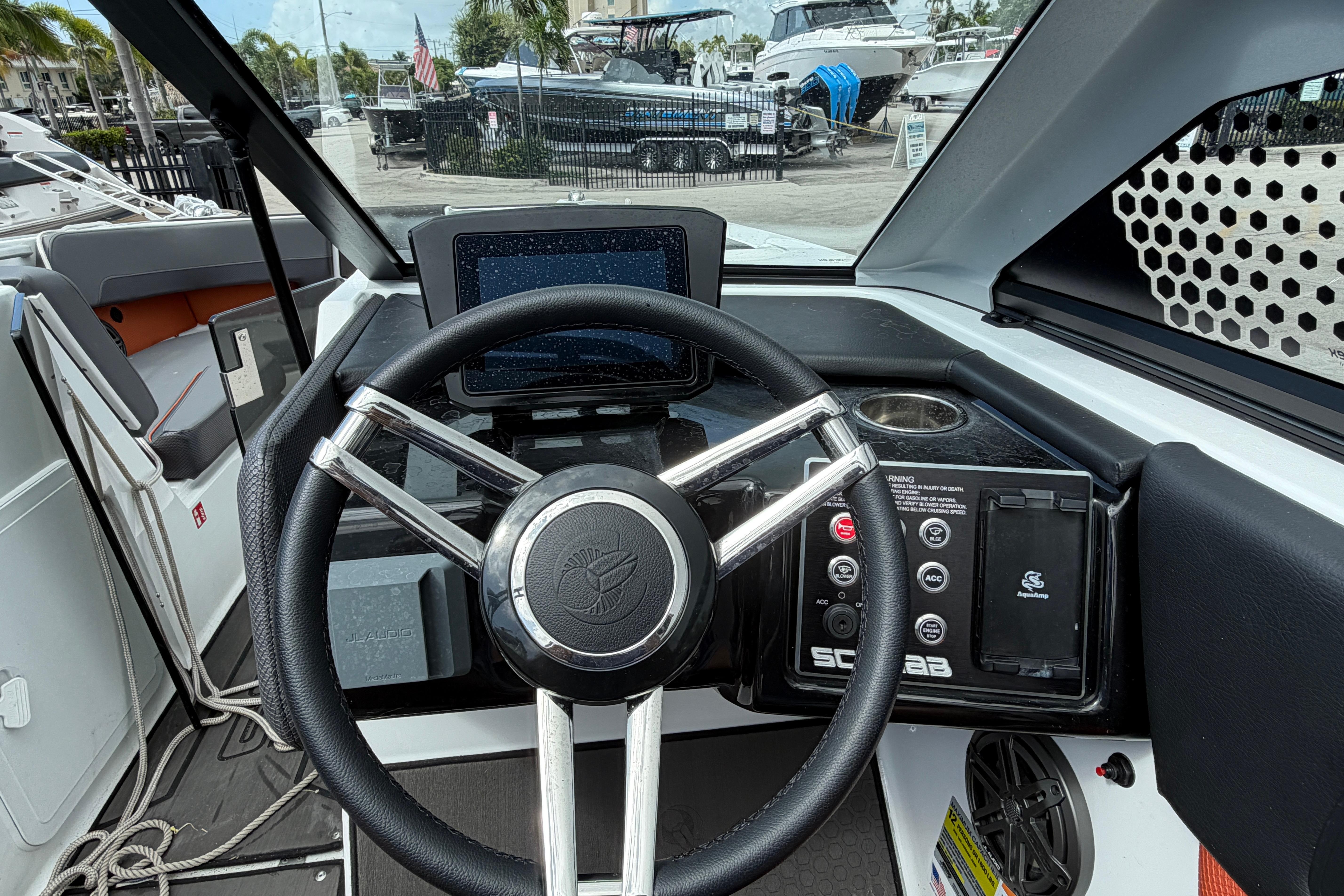 2026 Scarab 235 LX boat dashboard with steering wheel and control panel.