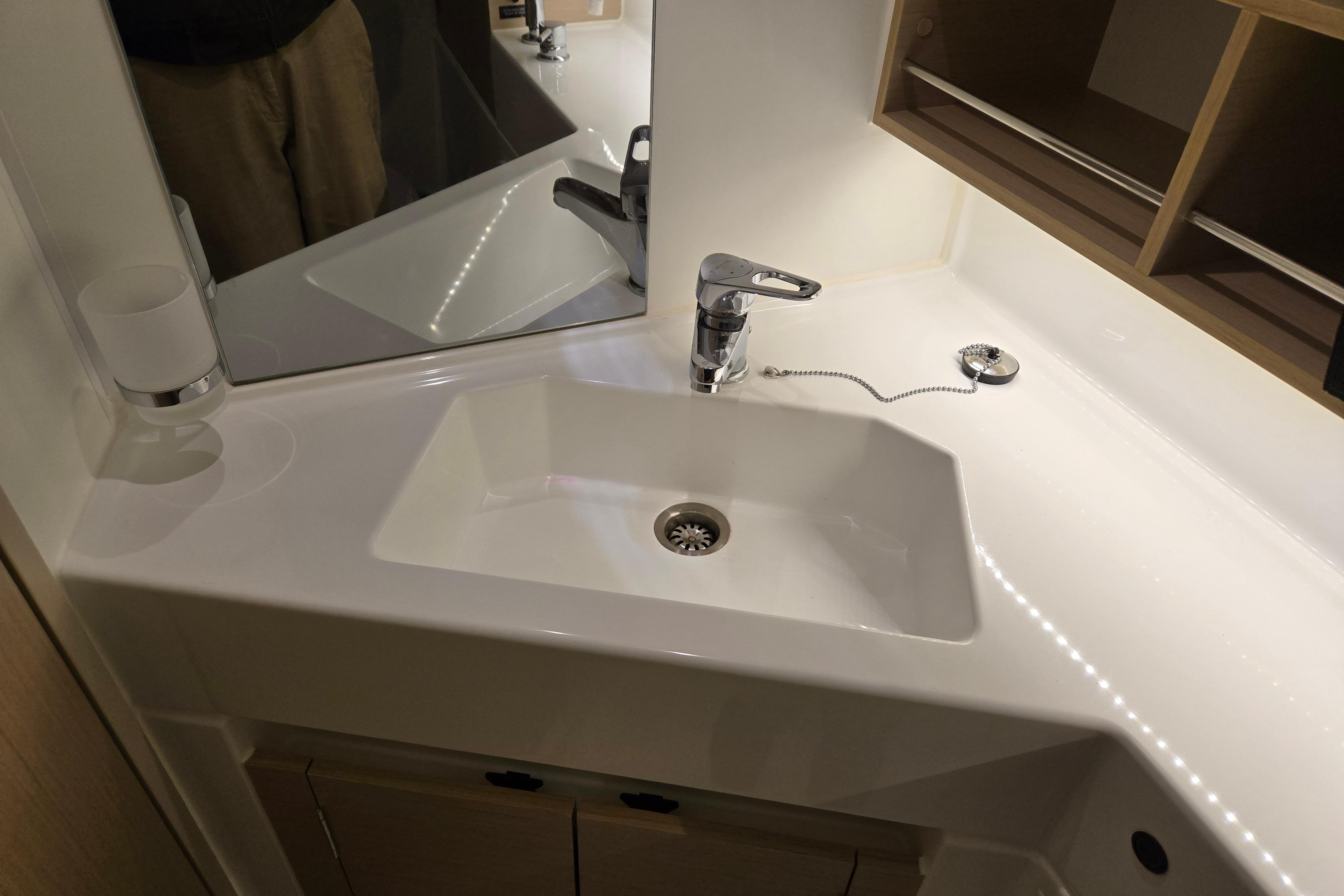 Modern bathroom sink in 2021 Beneteau Oceanis 30.1 yacht, featuring sleek design and fixtures.