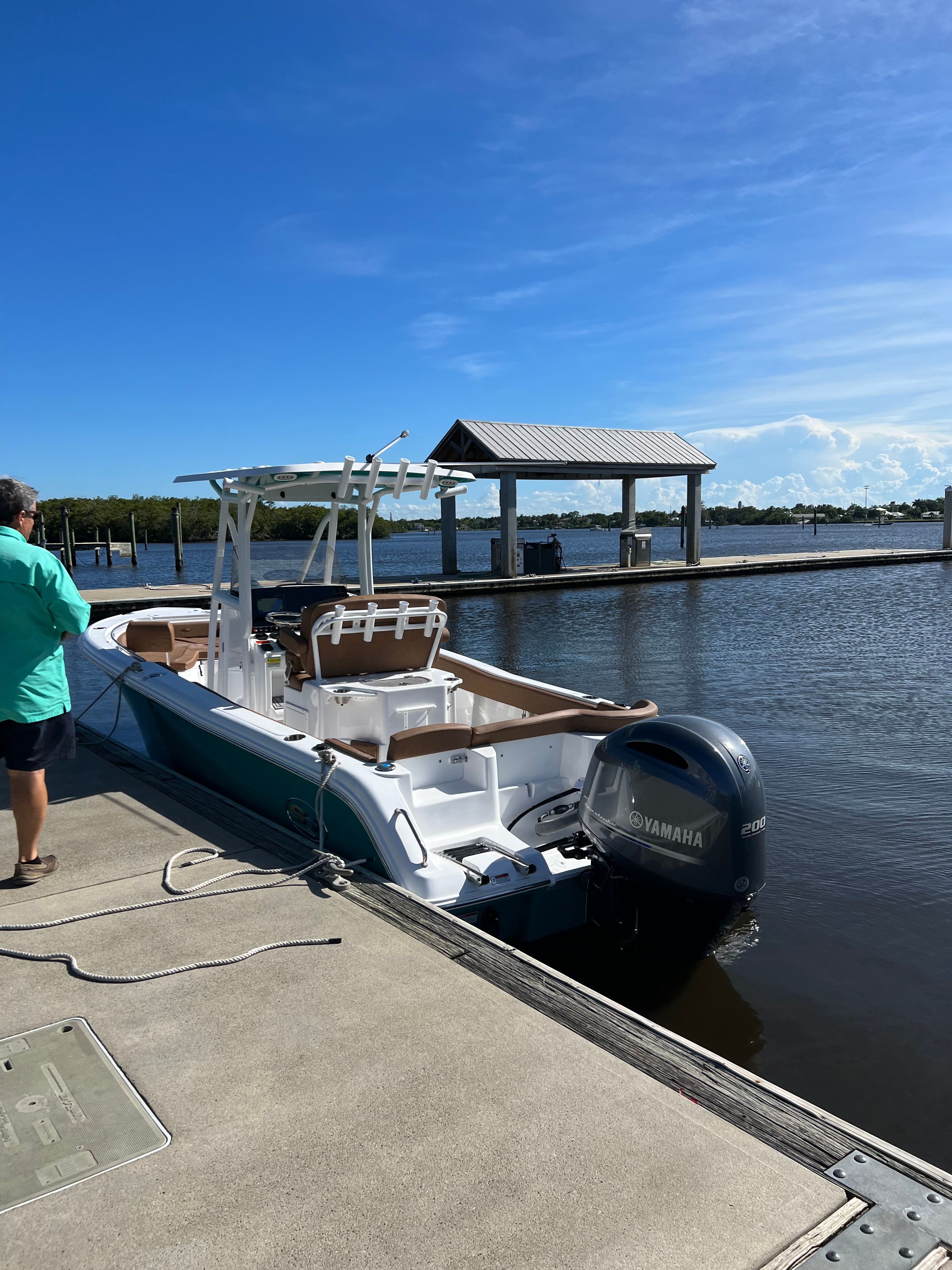 2022 Sea Hunt Ultra 234 boat docked on a sunny day.