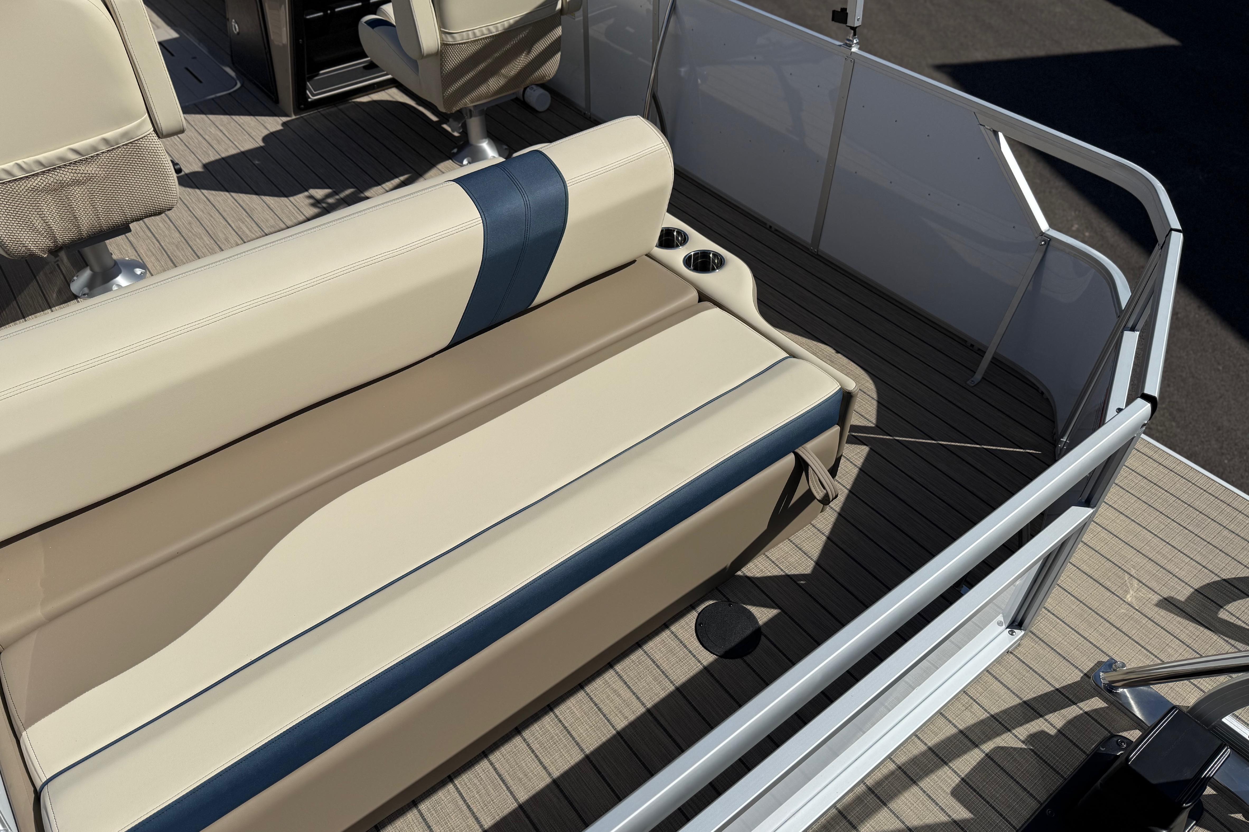 2026 SunCatcher Select 322SL boat interior with beige and blue seating, cup holders, and deck flooring.