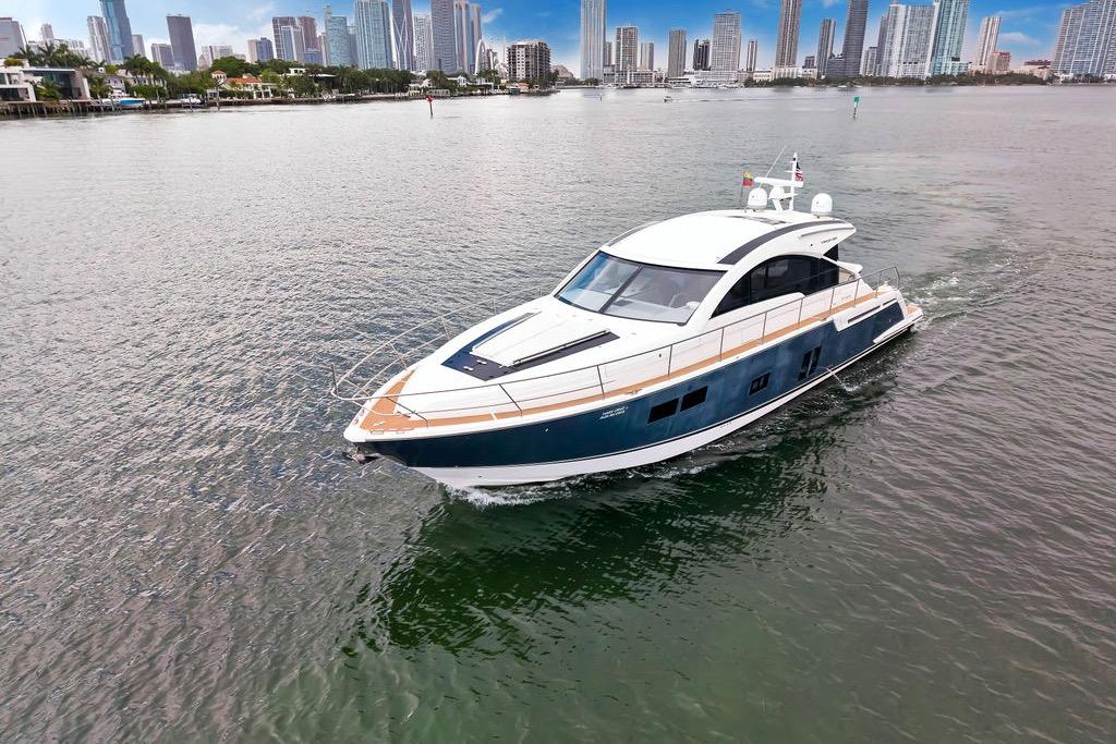 Luxury 2012 Fairline Targa 58 yacht cruising near city skyline.