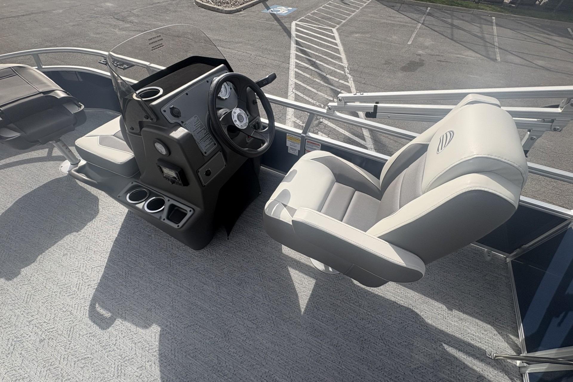 2026 Sun Tracker Bass Buggy 18 DLX boat interior with steering console and seating.