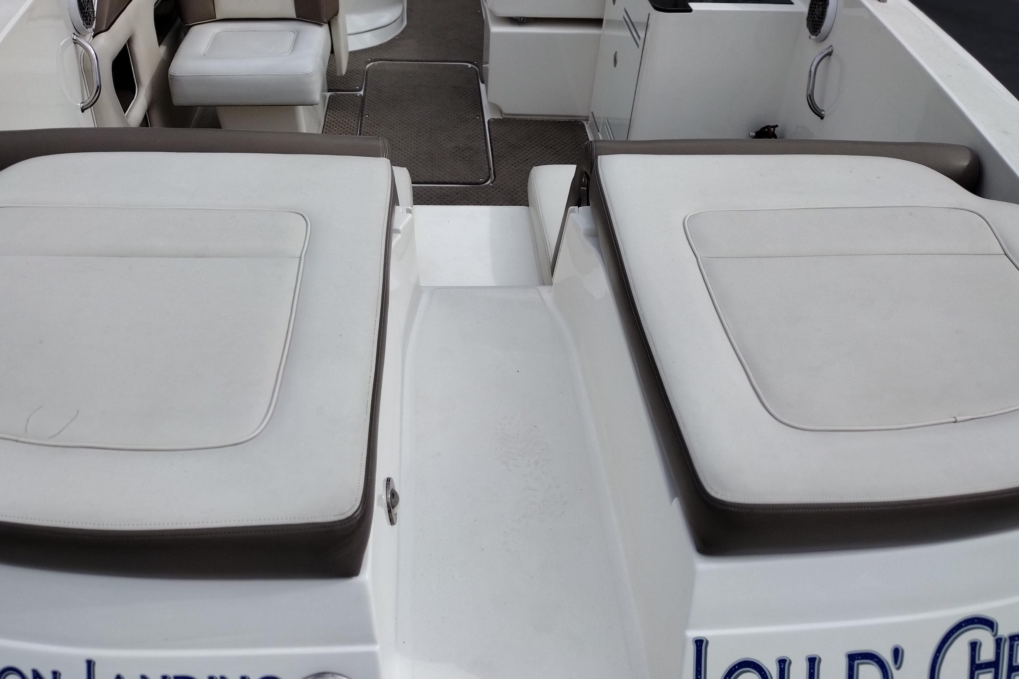 Interior view of a 2013 Sea Ray 300 SLX boat, featuring cushioned seating and deck area.