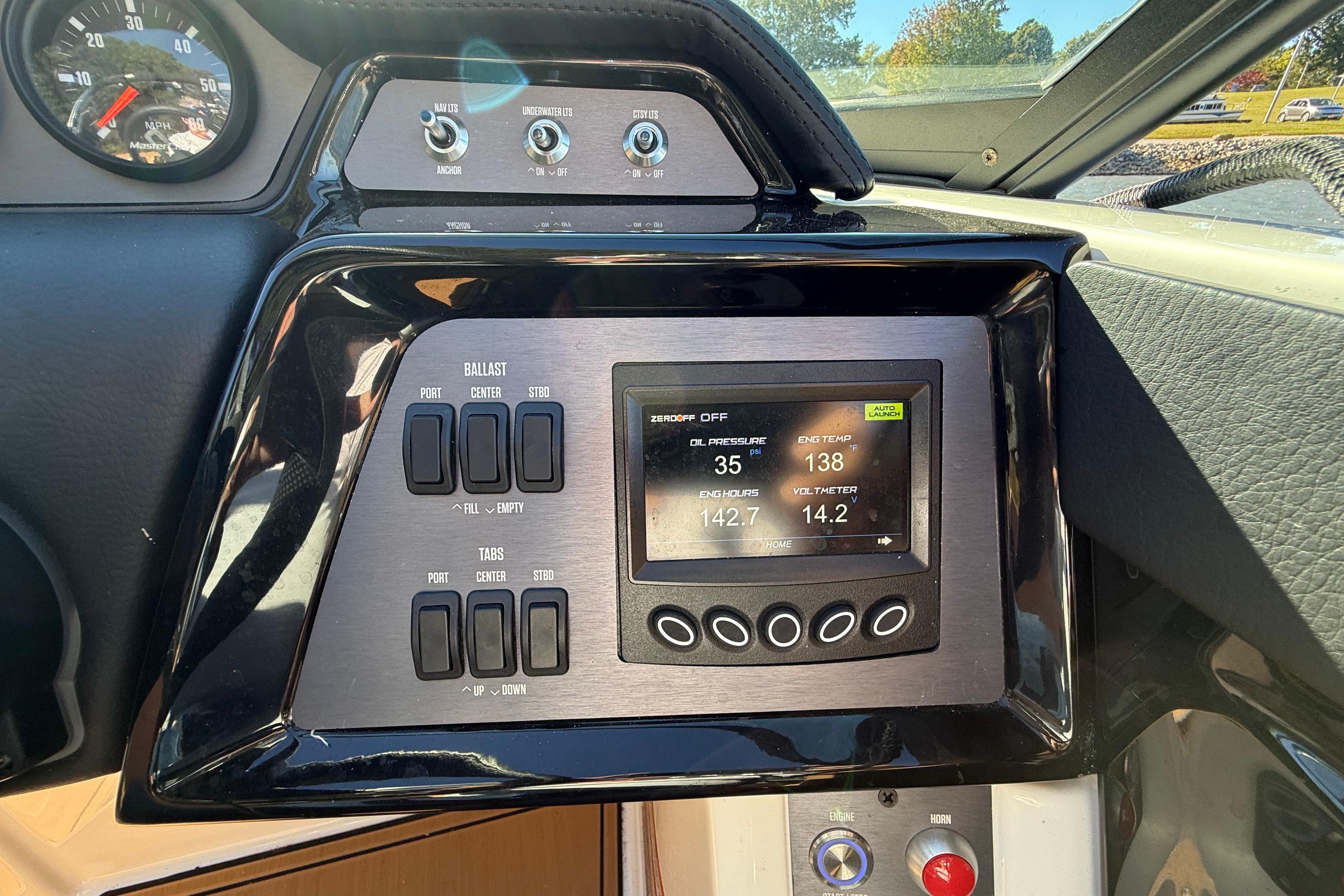 Control panel of a 2022 MasterCraft NXT24 boat with digital display and switches.
