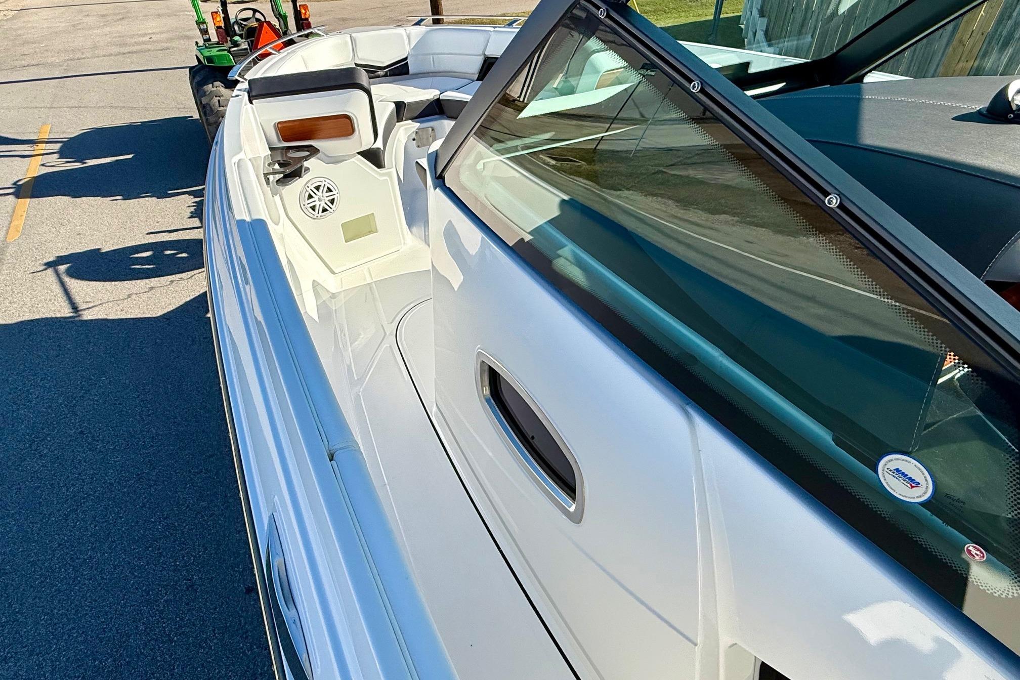 2026 Monterey Elite 27 OB boat, side view with interior features.