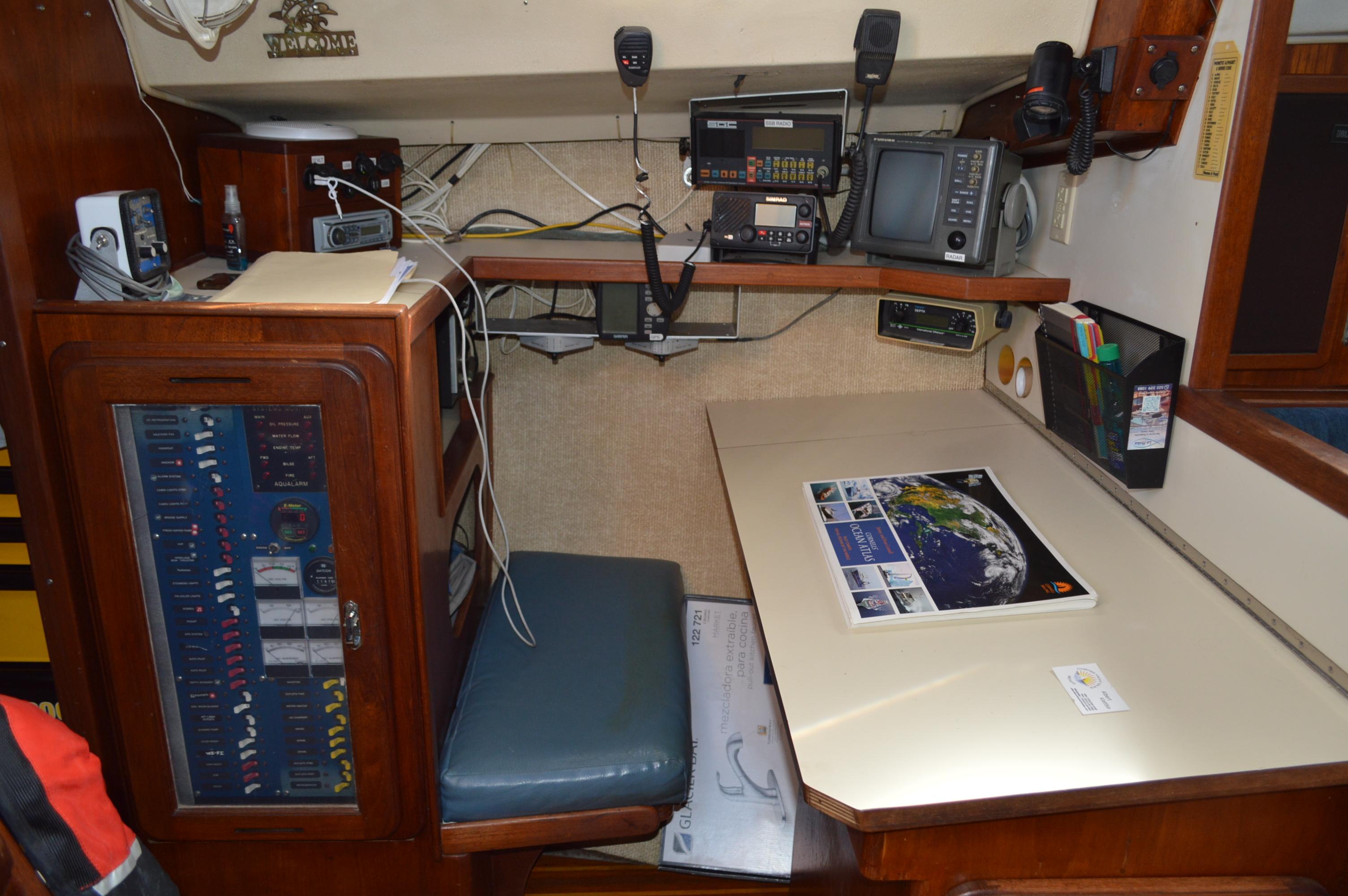 Navigation station inside a 1979 Morgan 461 yacht, featuring communication equipment and a chart table.