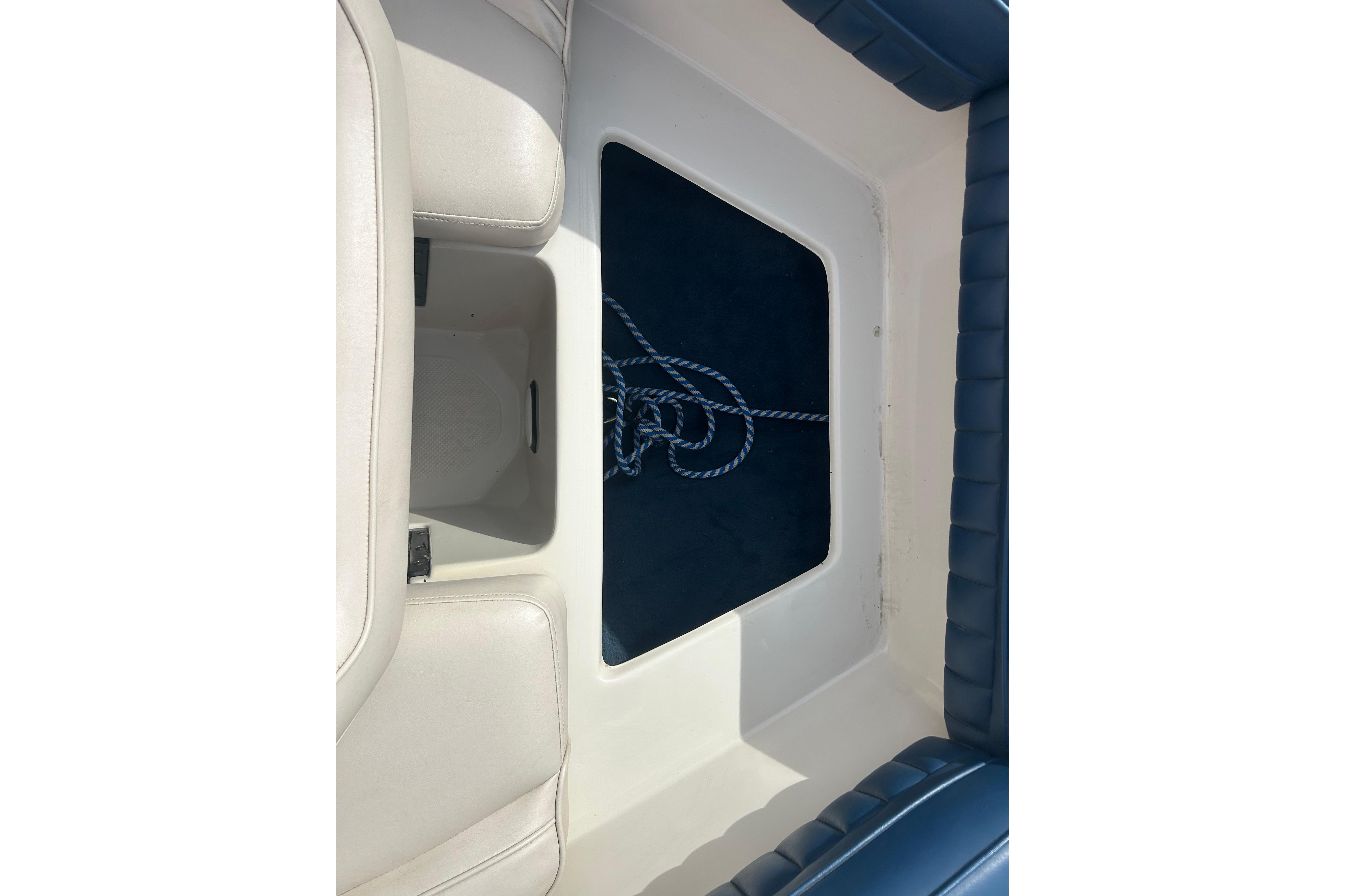 Interior view of a 1996 Mariah 180 Shabah boat with seating and storage area.