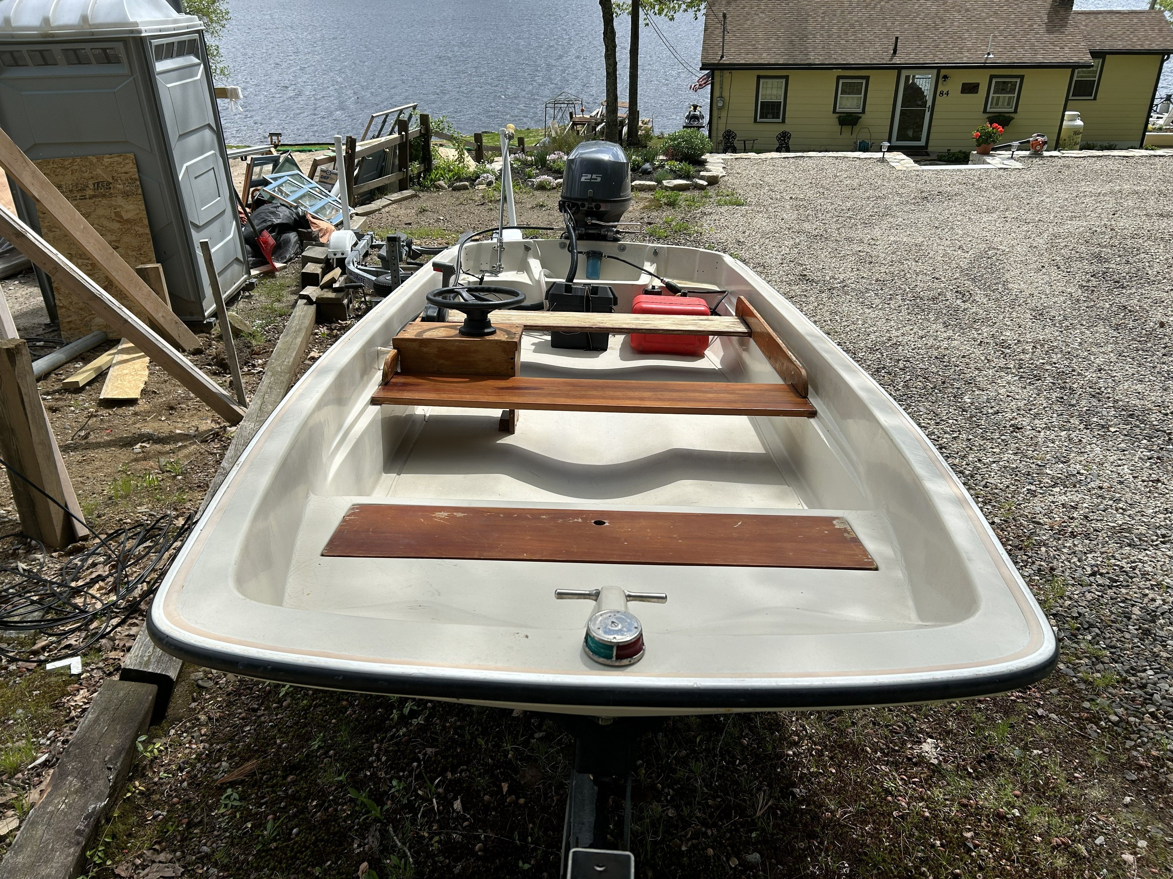 1975 Boston Whaler 13 ft boat parked by lakeside.