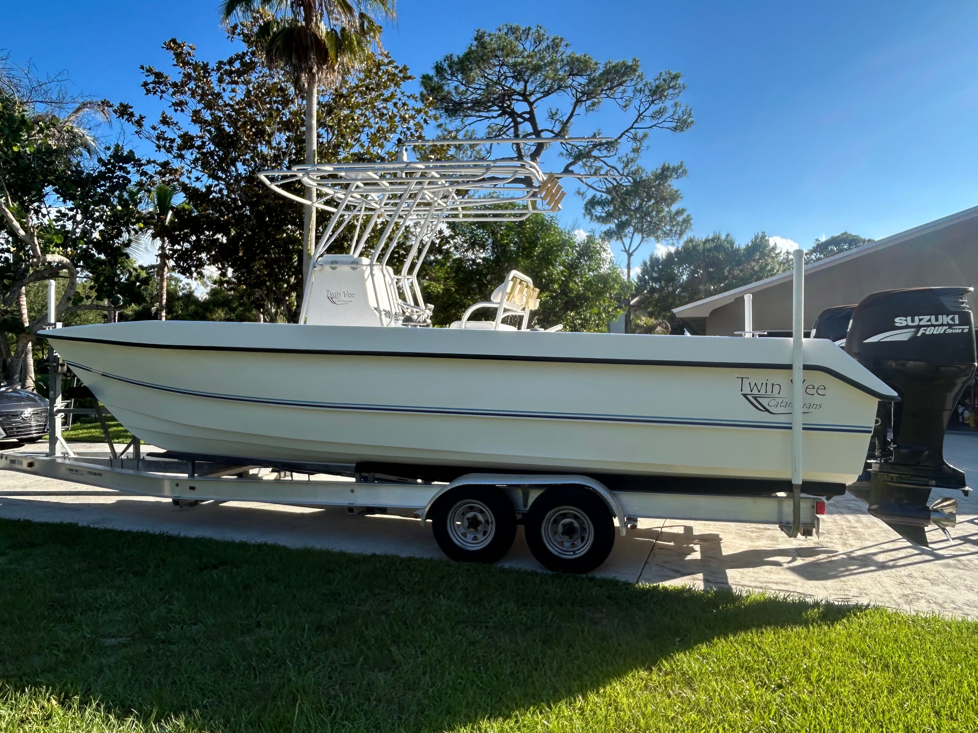 A 2007 Twin Vee 26 Center Console boat on a trailer outdoors.