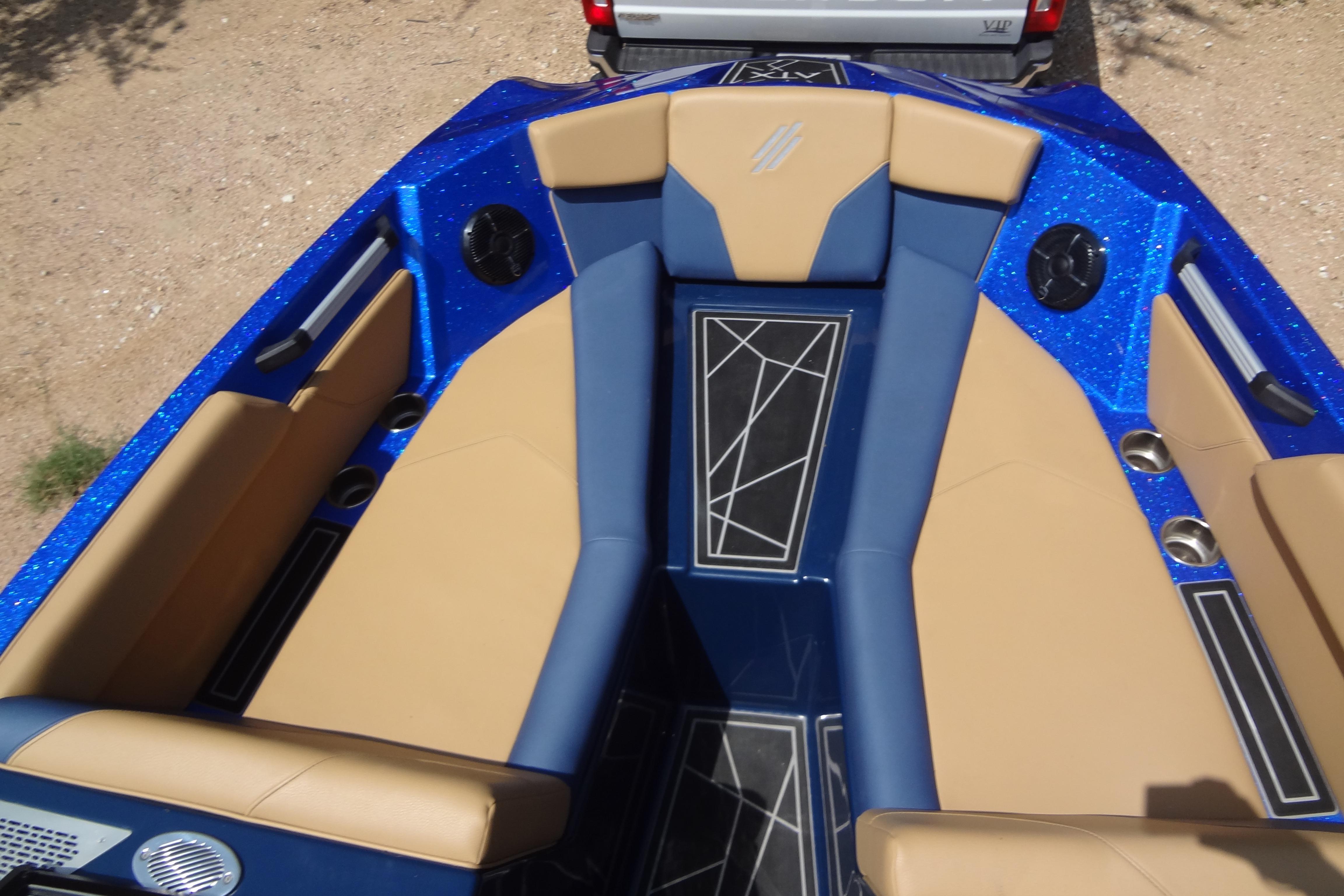 2022 ATX Surf Boats 24 Type-S interior with blue and tan seating, geometric floor design.