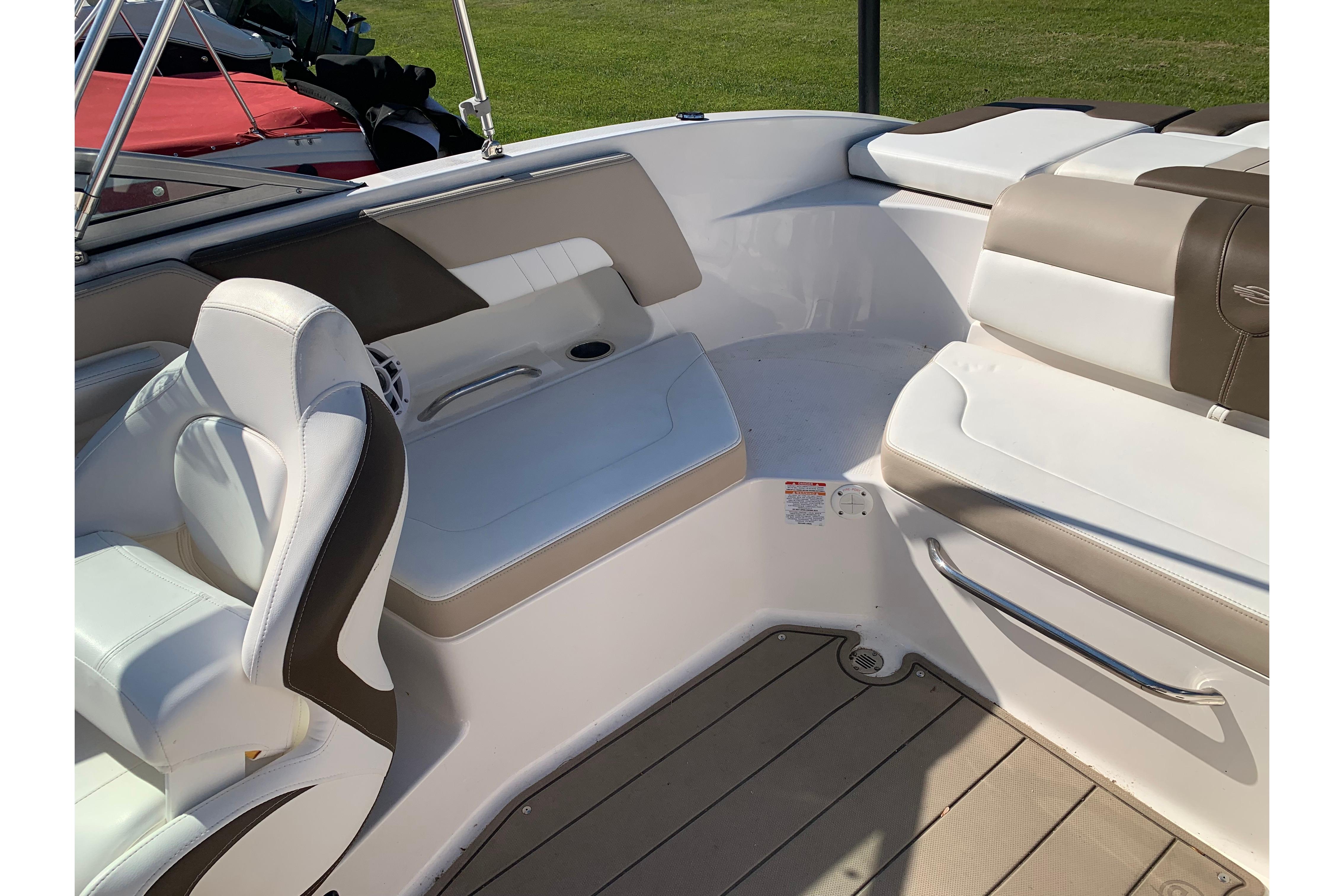 Interior of 2022 Chaparral 23 SSi boat with white and beige seating.