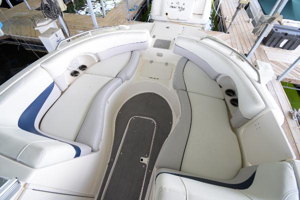 The image shows the spacious cockpit of a Bryant 255 boat with white upholstery.