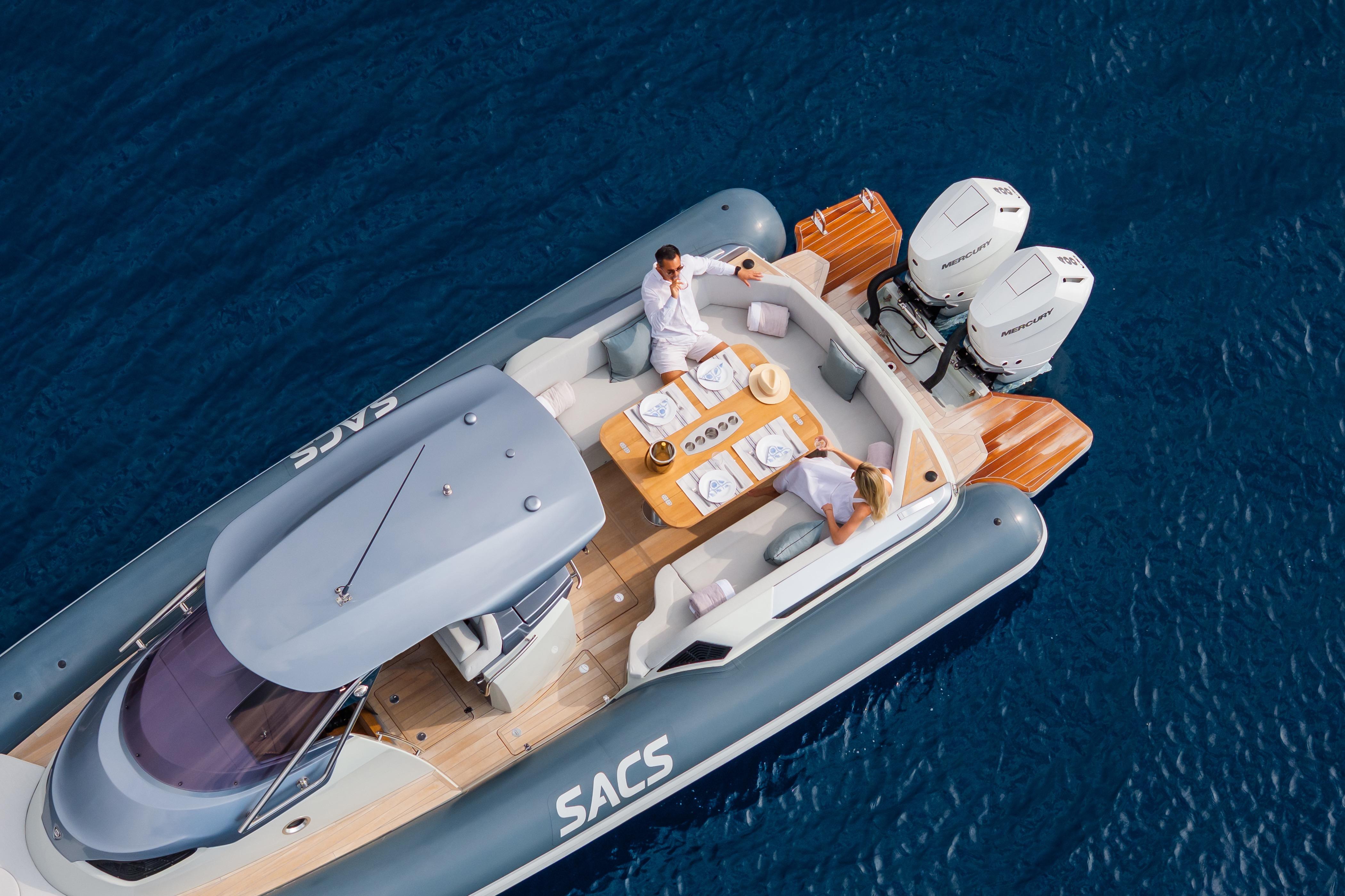 2025 SACS STRIDER 11 OPEN BACK luxury boat on blue water, featuring elegant deck seating.