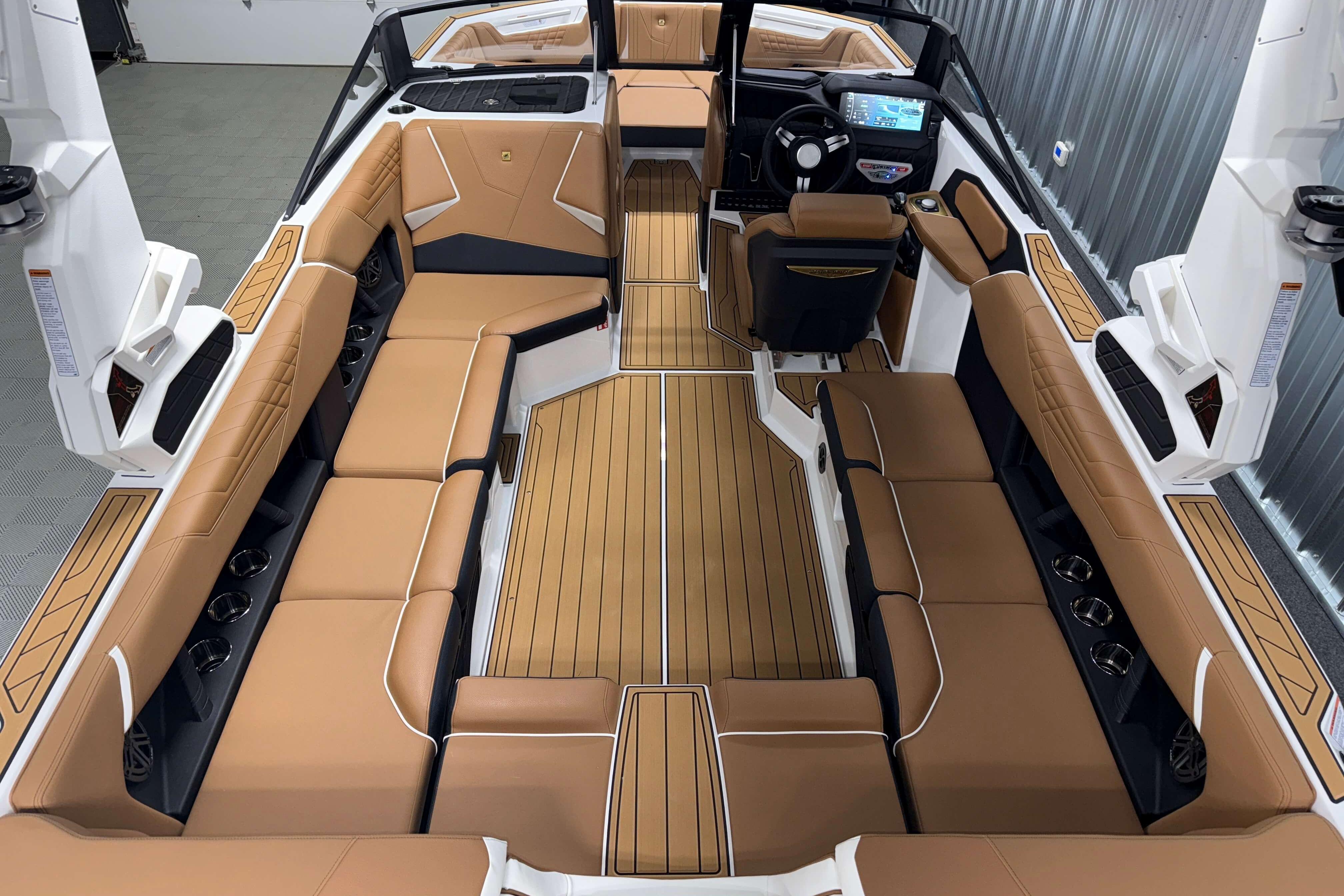 2026 Nautique Super Air Nautique S23 interior with tan seating and modern dashboard.