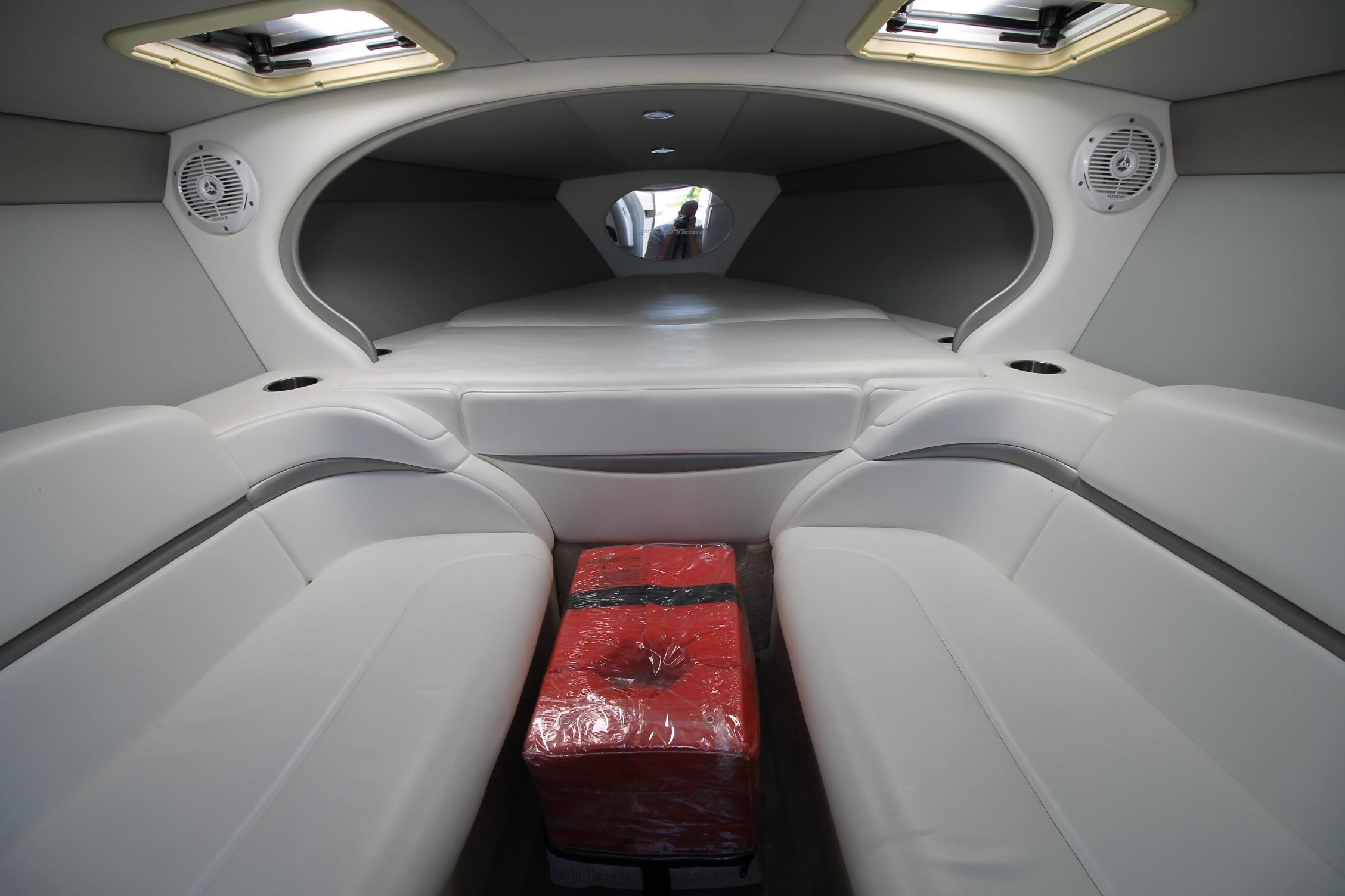 Interior of 2006 Formula 292 FASTech boat with white seating and red package.