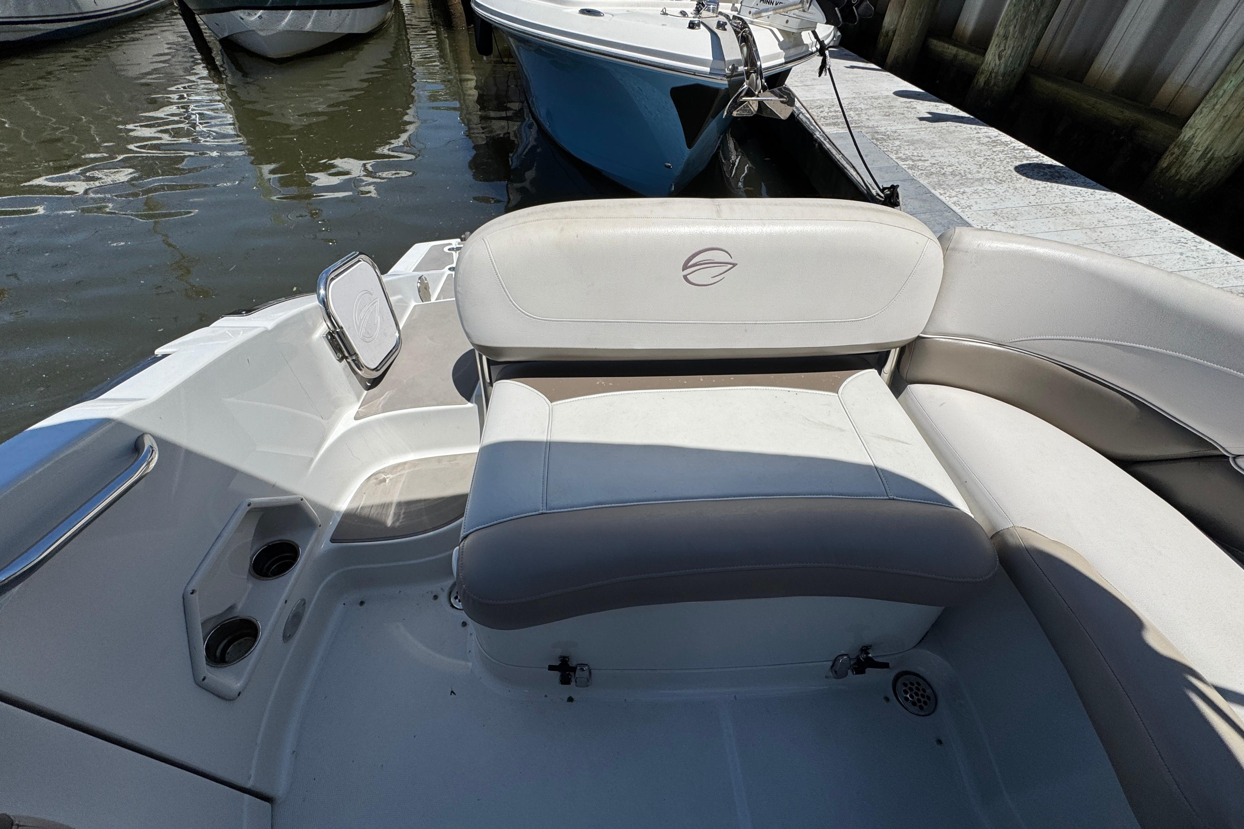 2013 Crownline Eclipse E6 XS boat interior with cushioned seating and cup holders.