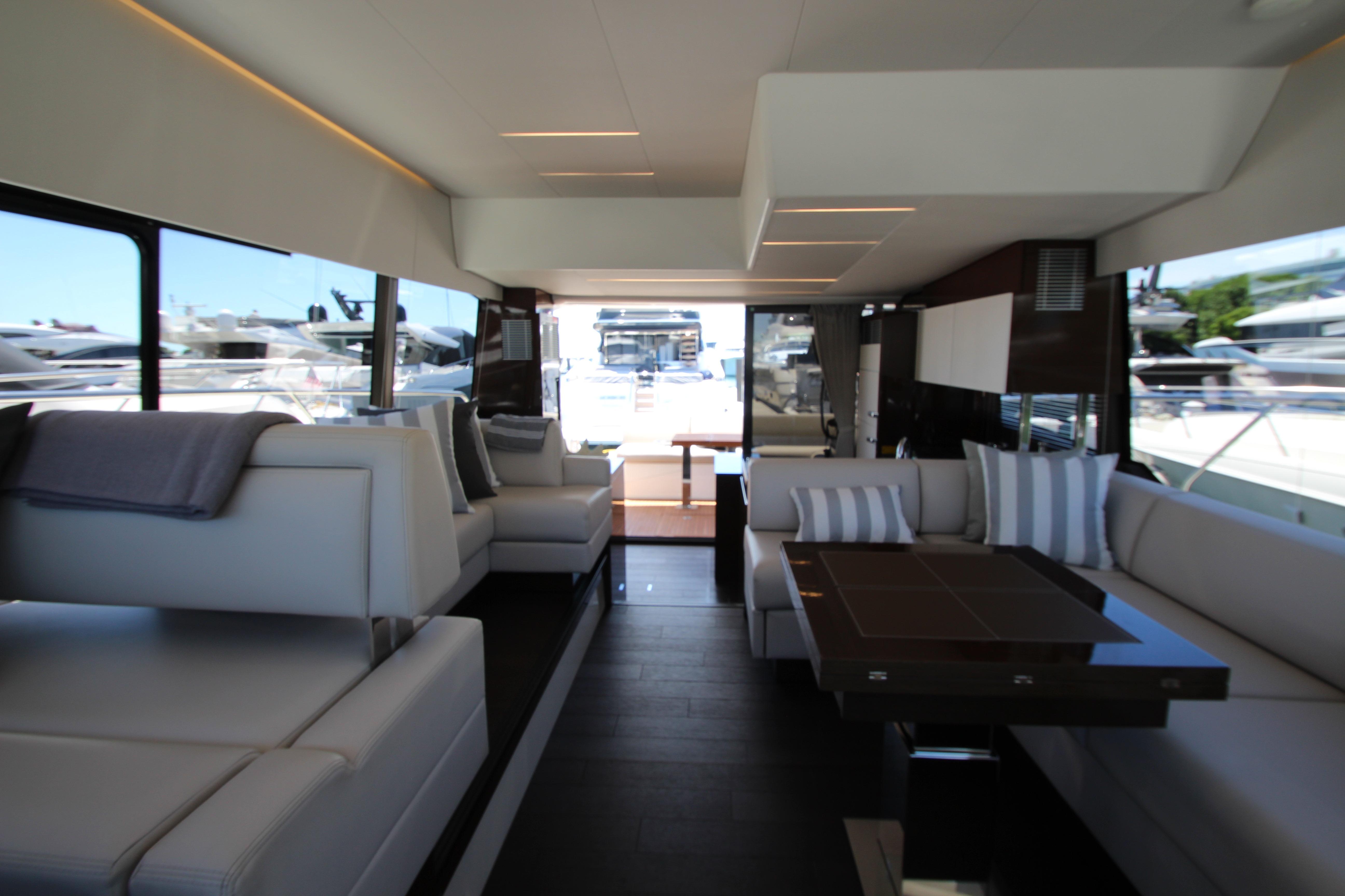 Luxurious interior of 2022 Prestige 520 yacht with modern seating and elegant design.
