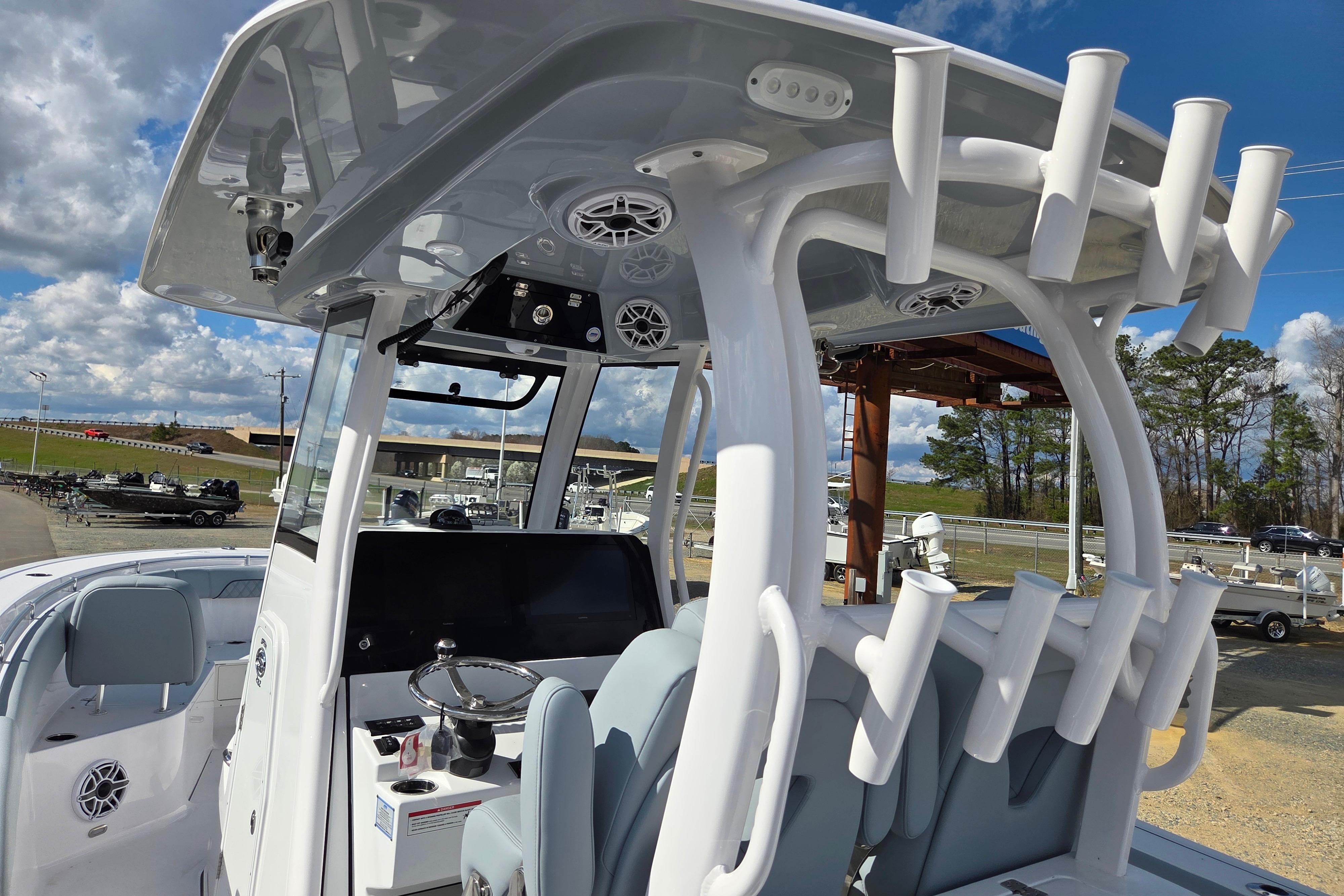 2026 Sportsman Open 282 Center Console boat with rod holders and modern helm.