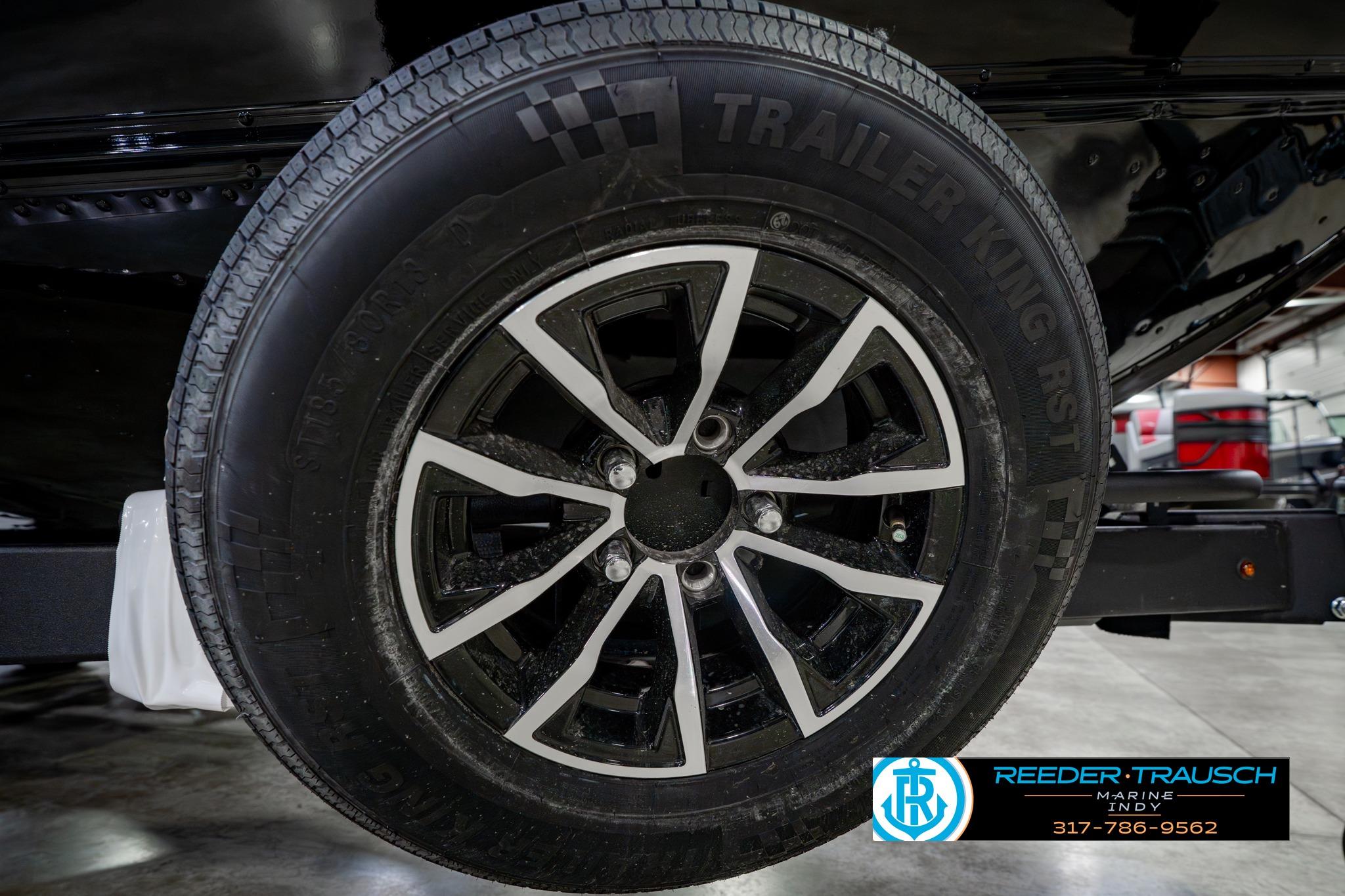 2026 Lund 1875 Impact XS trailer wheel with Trailer King RST tire in showroom.