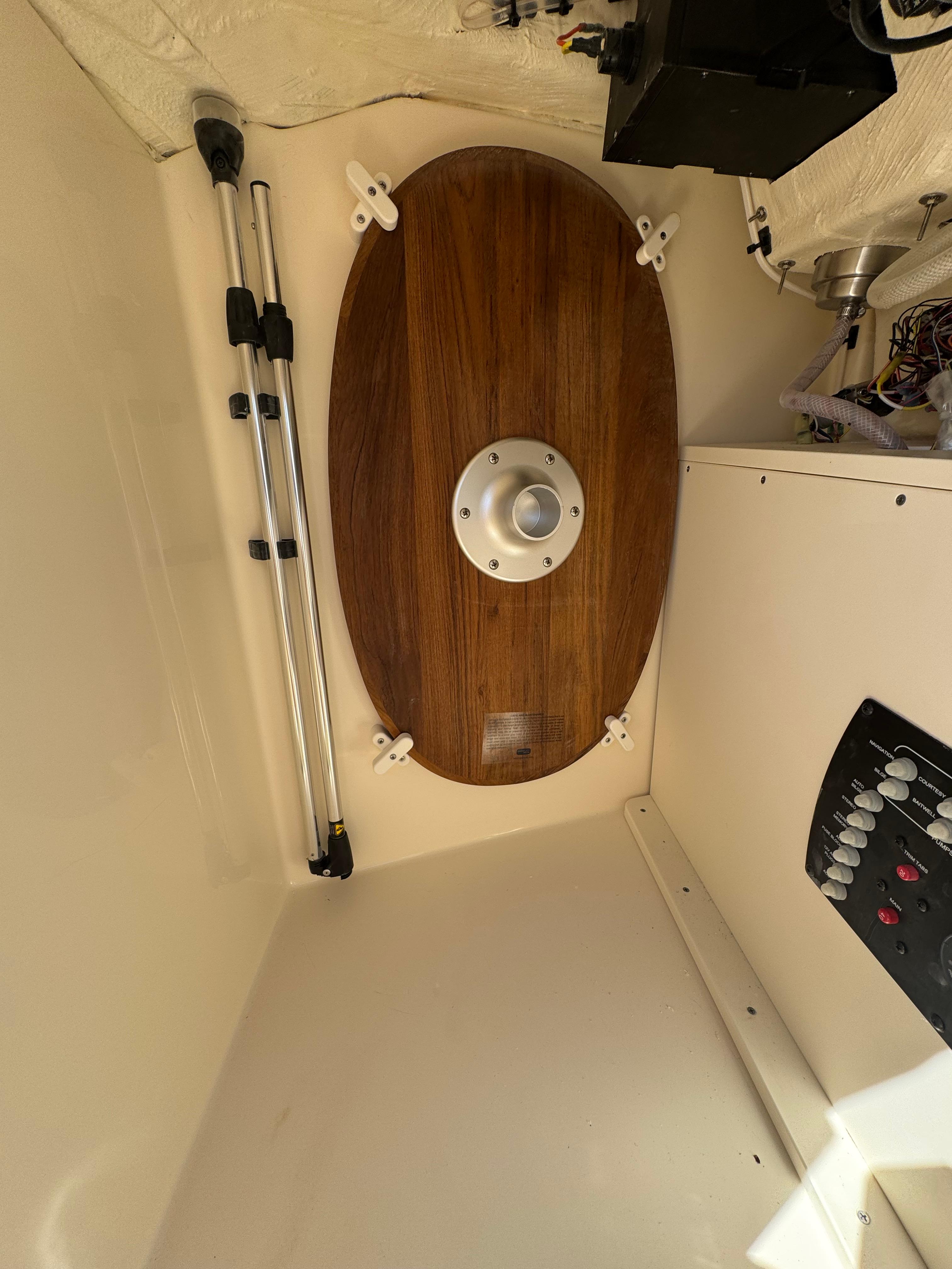 Interior view of 2025 Scout 215 Dorado boat, featuring wooden panel and control panel.