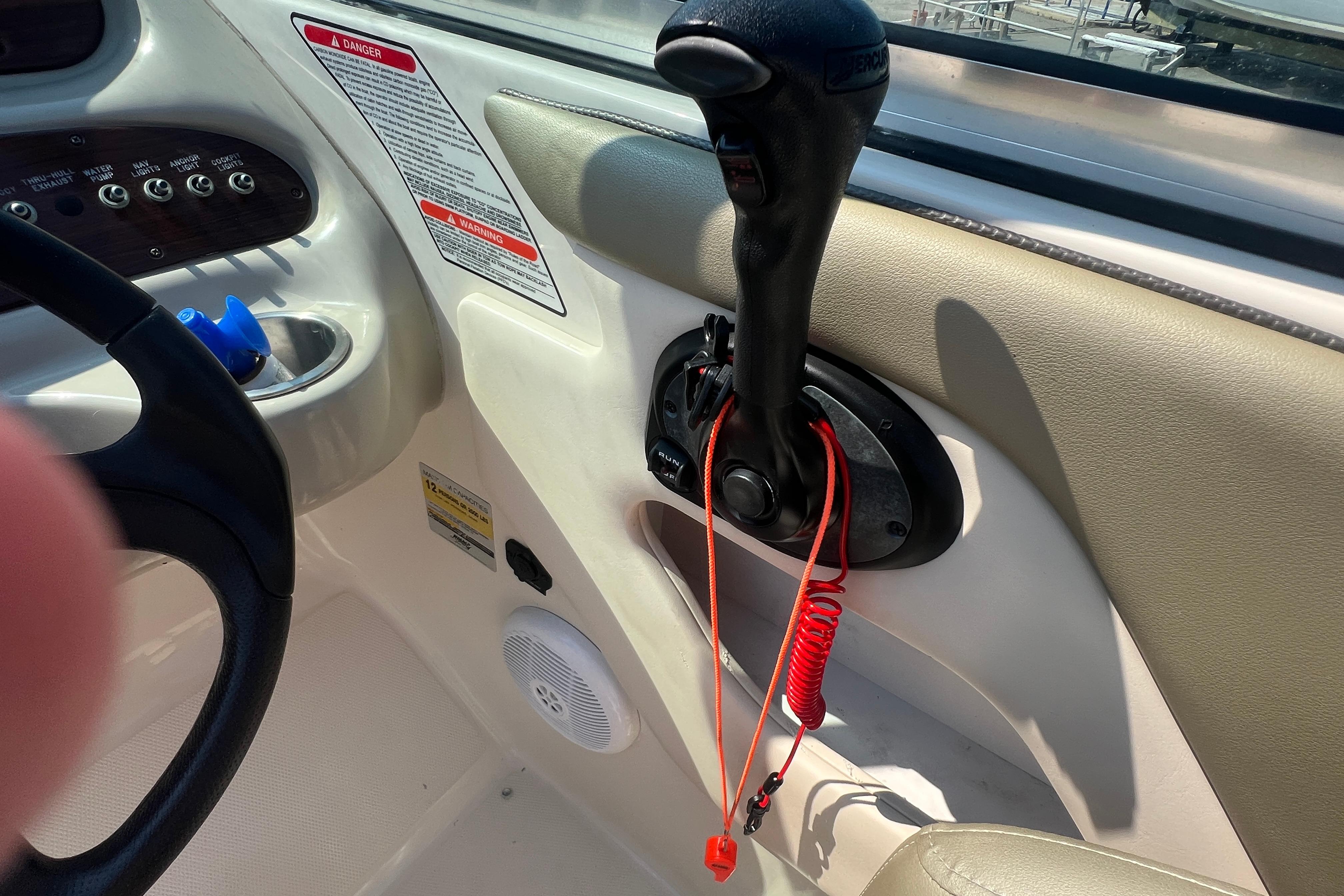 2005 Sea Ray 240 Sundeck boat controls with throttle and safety lanyard.