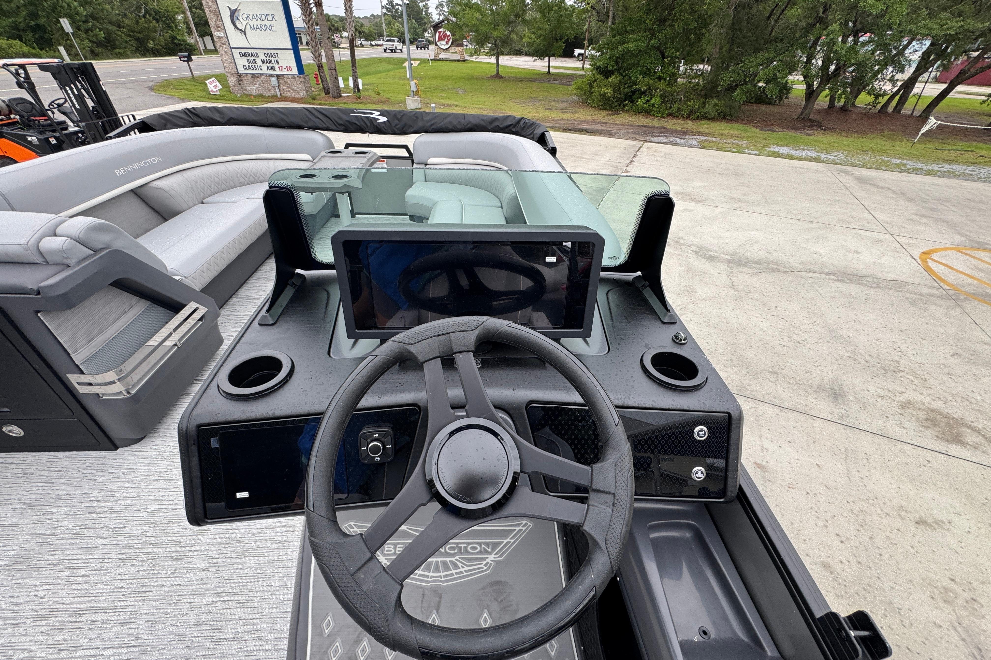 2027 Bennington 24 MFB boat dashboard with steering wheel and modern controls.
