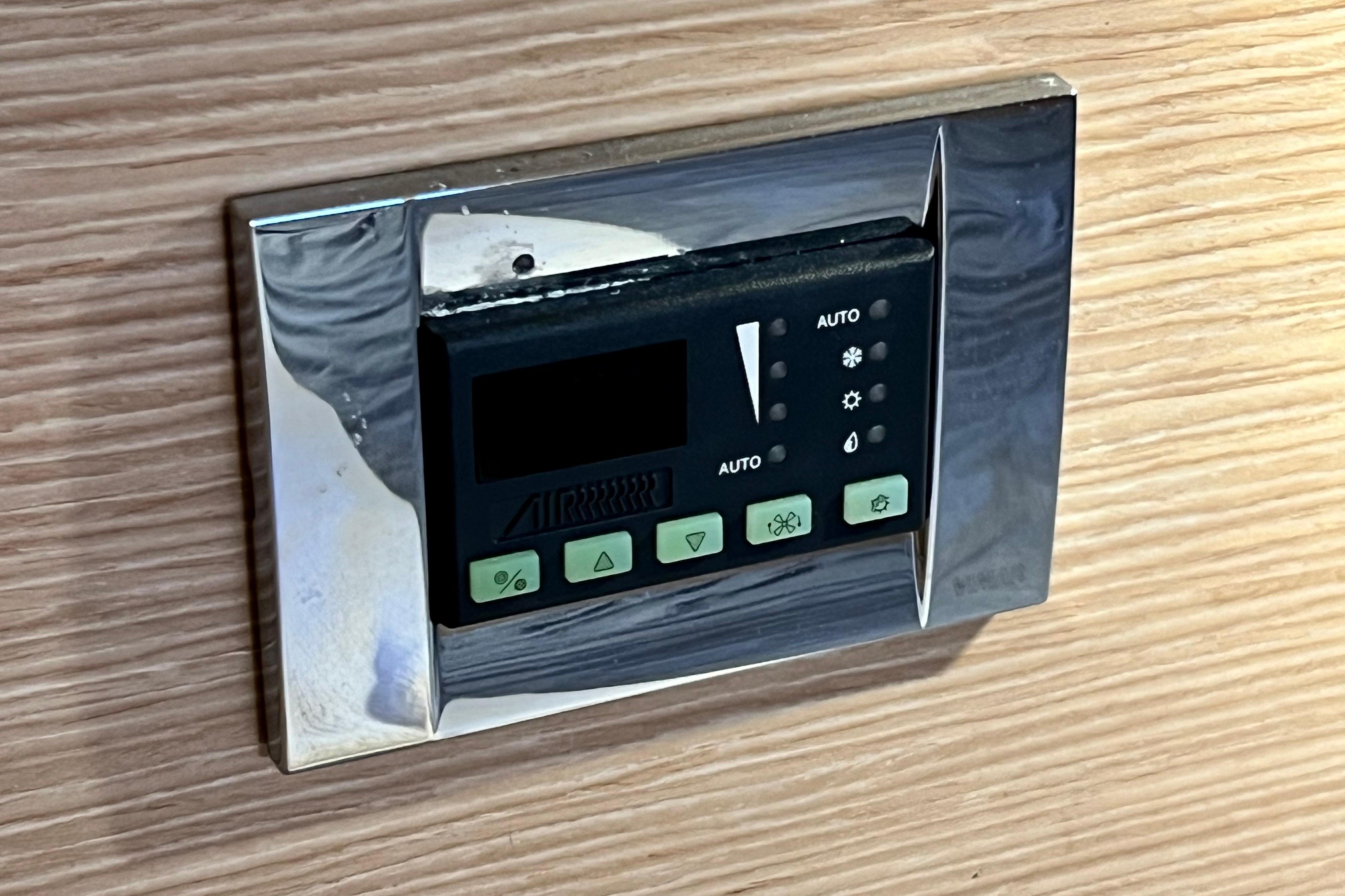 Digital control panel on a 2016 Hanse 455 yacht, mounted on wooden interior.