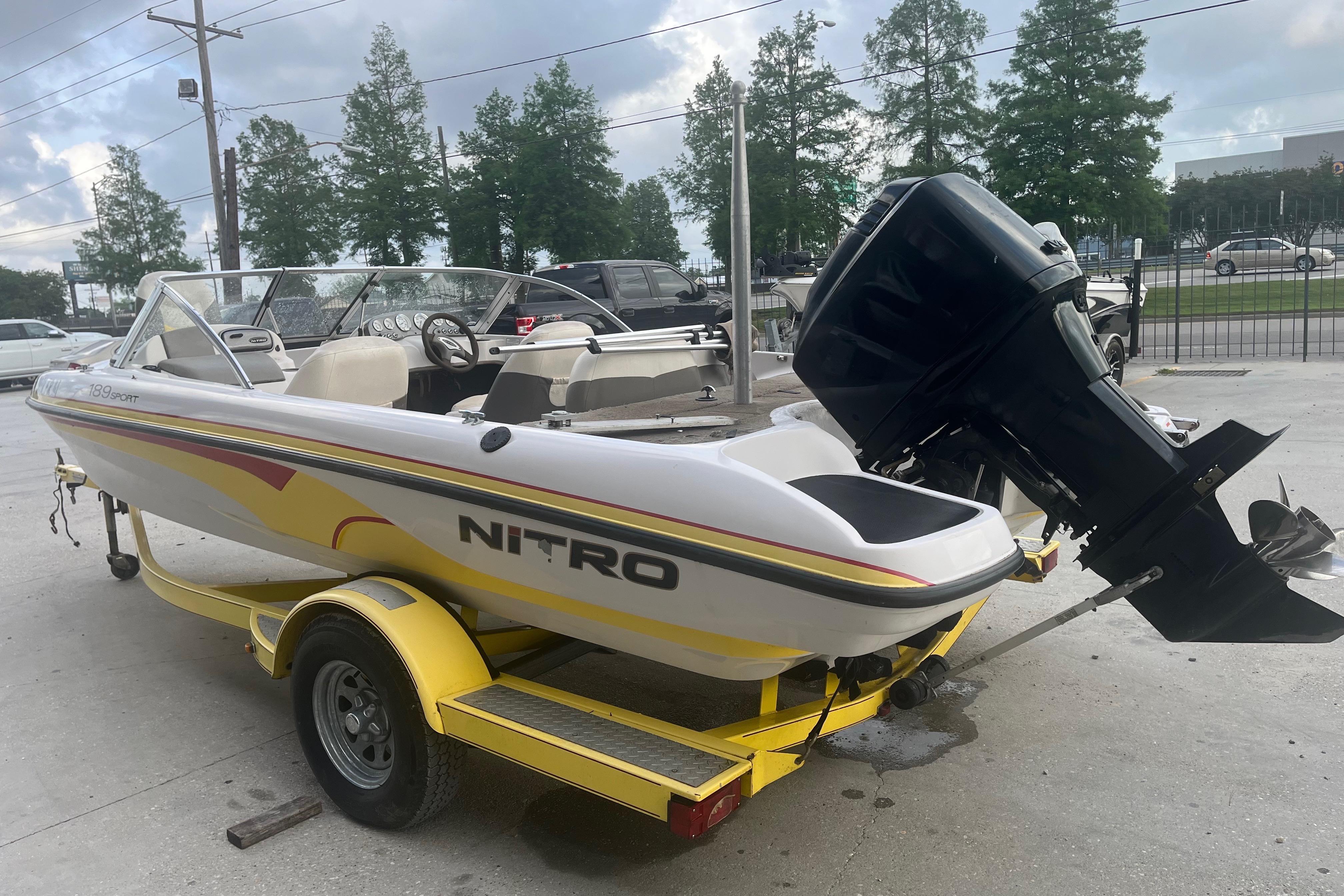 2006 Nitro 189 Sport boat on yellow trailer, parked outdoors.